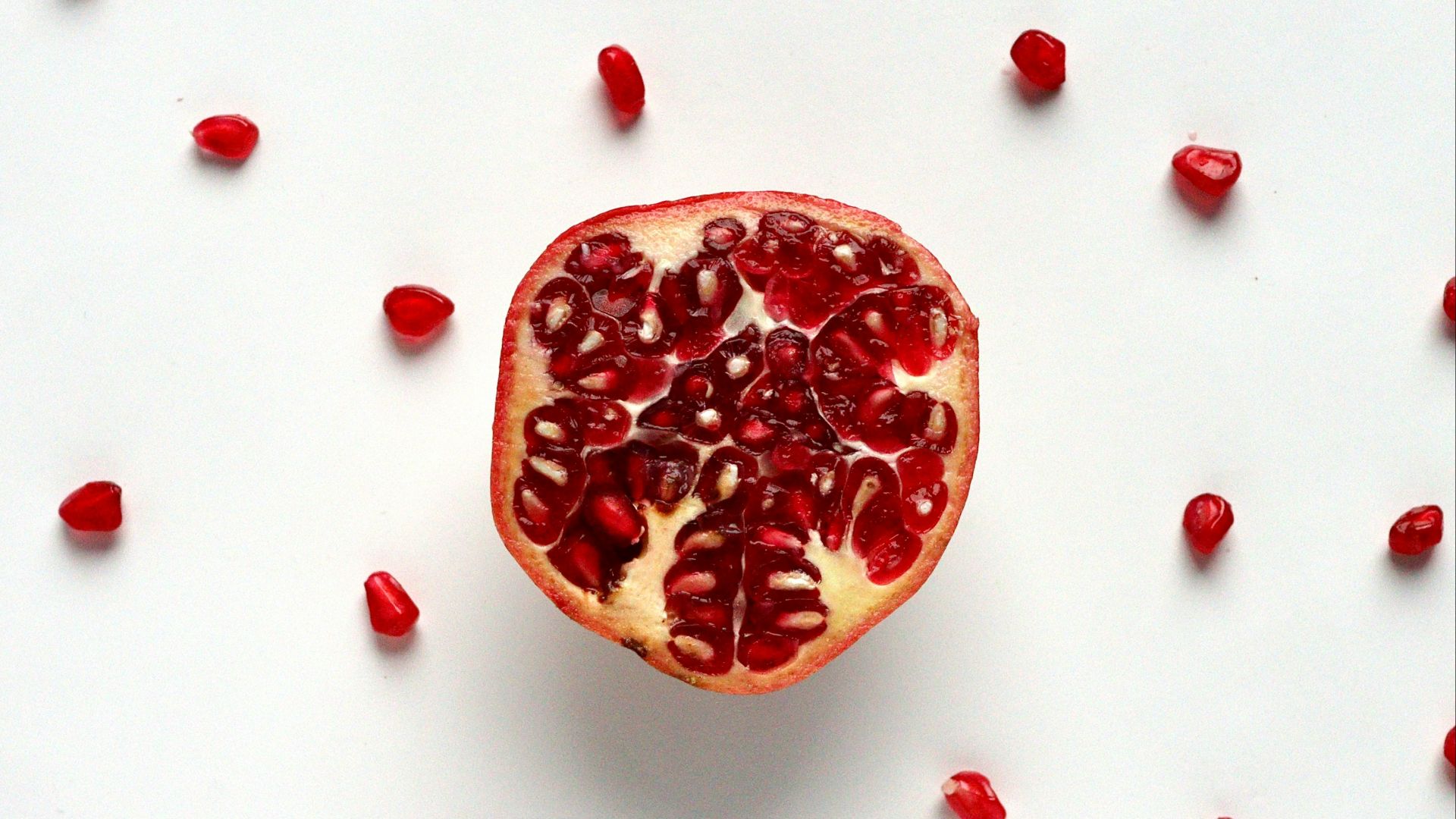 red sliced fruit on white surface