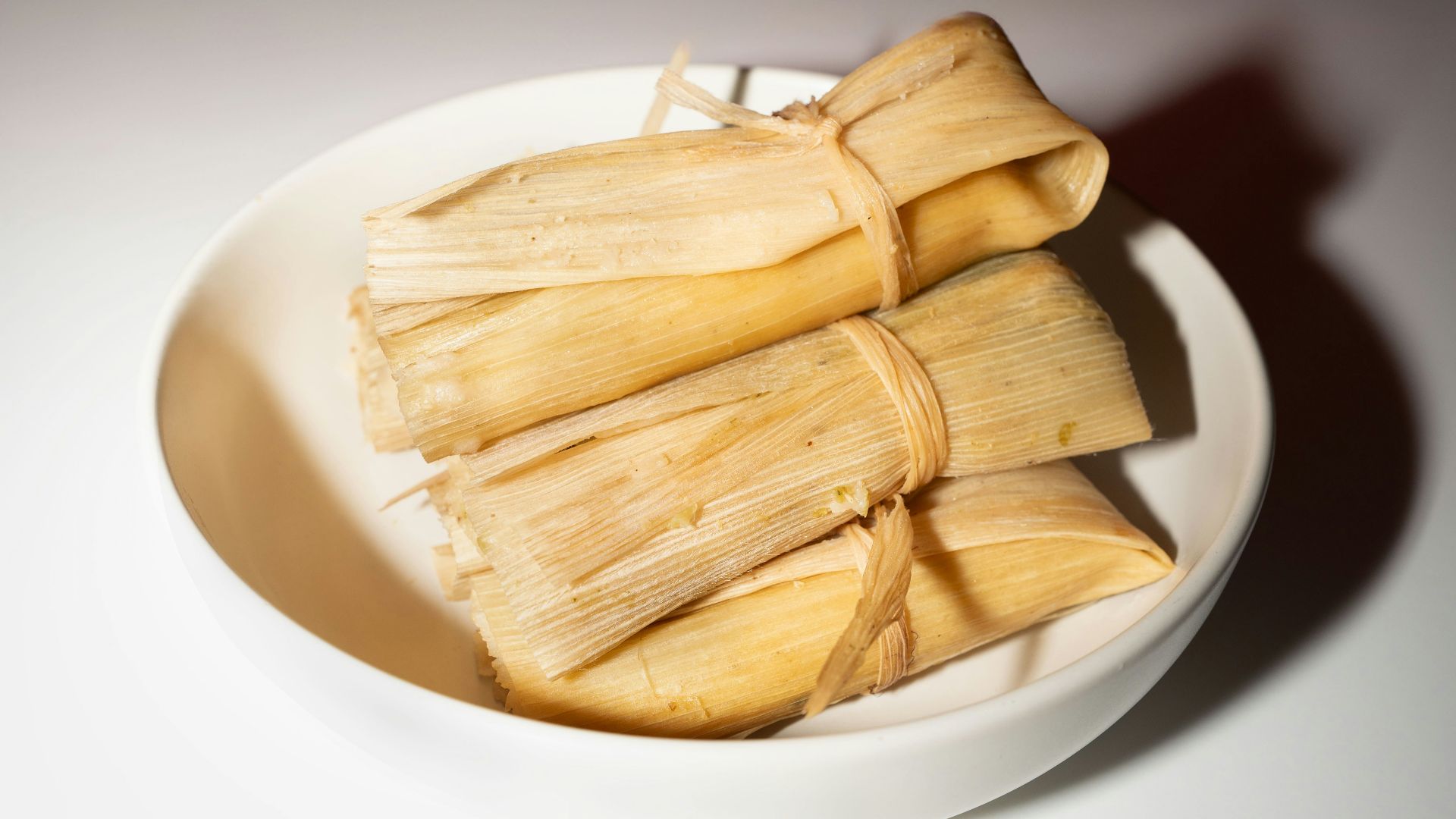 A white bowl filled with food on top of a table
