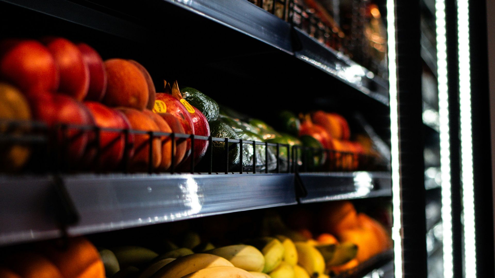 a display in a grocery store filled with lots of fruits and vegetables