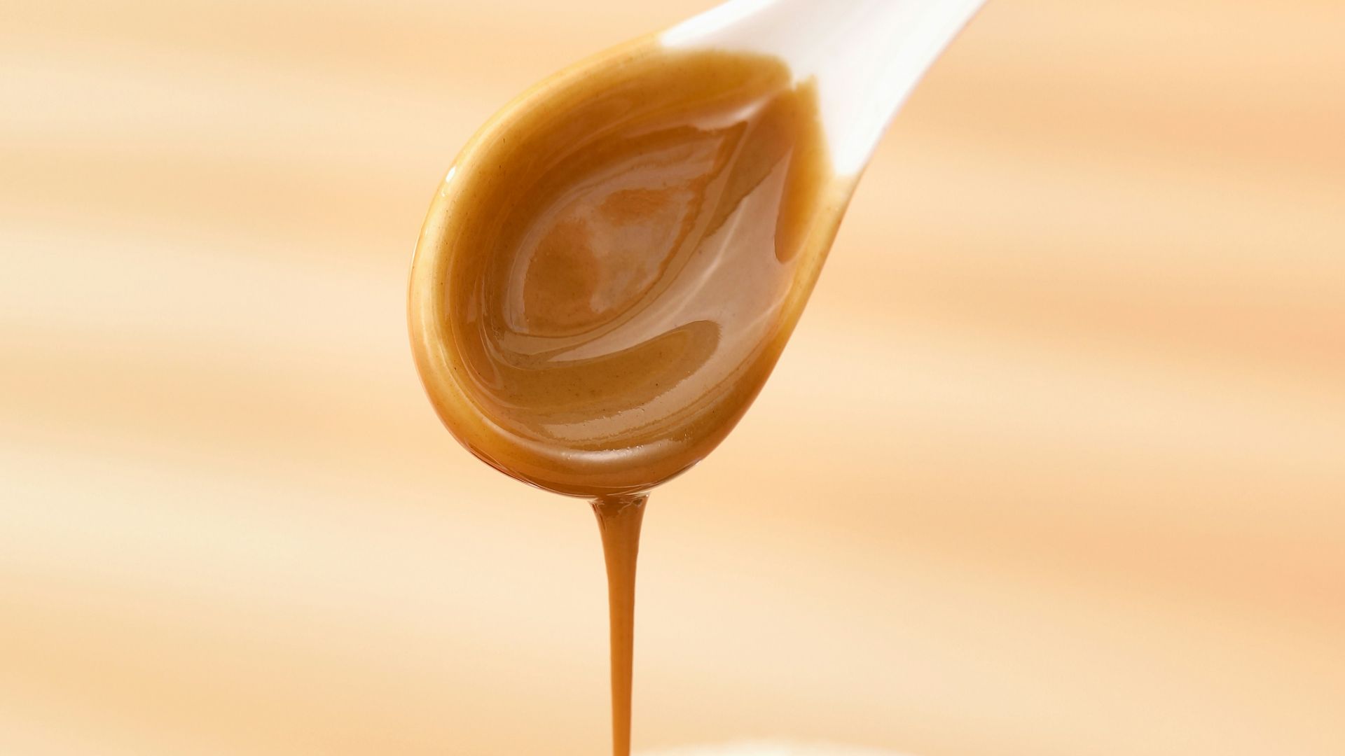 a person dipping sauce into a bowl of food