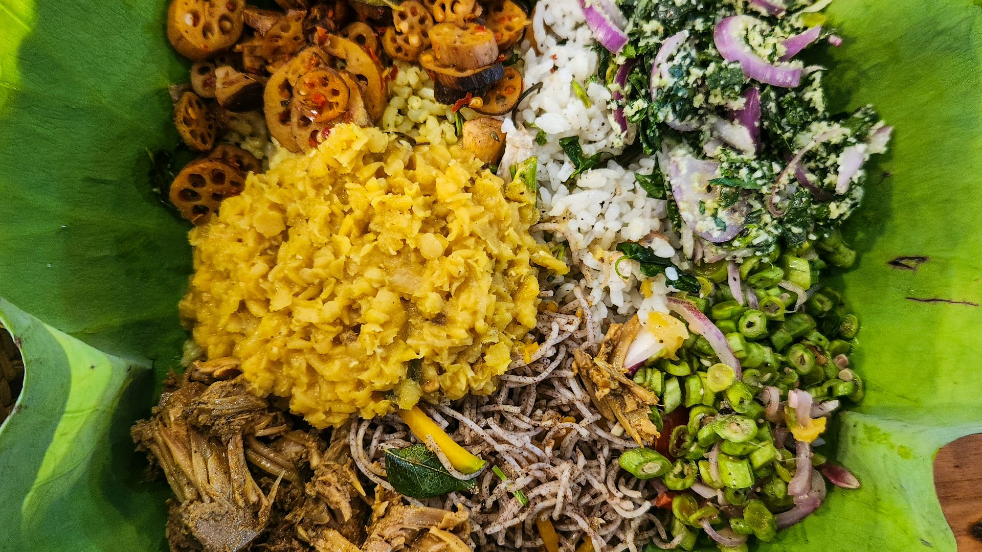 A sri lankan meal is presented on a leaf.