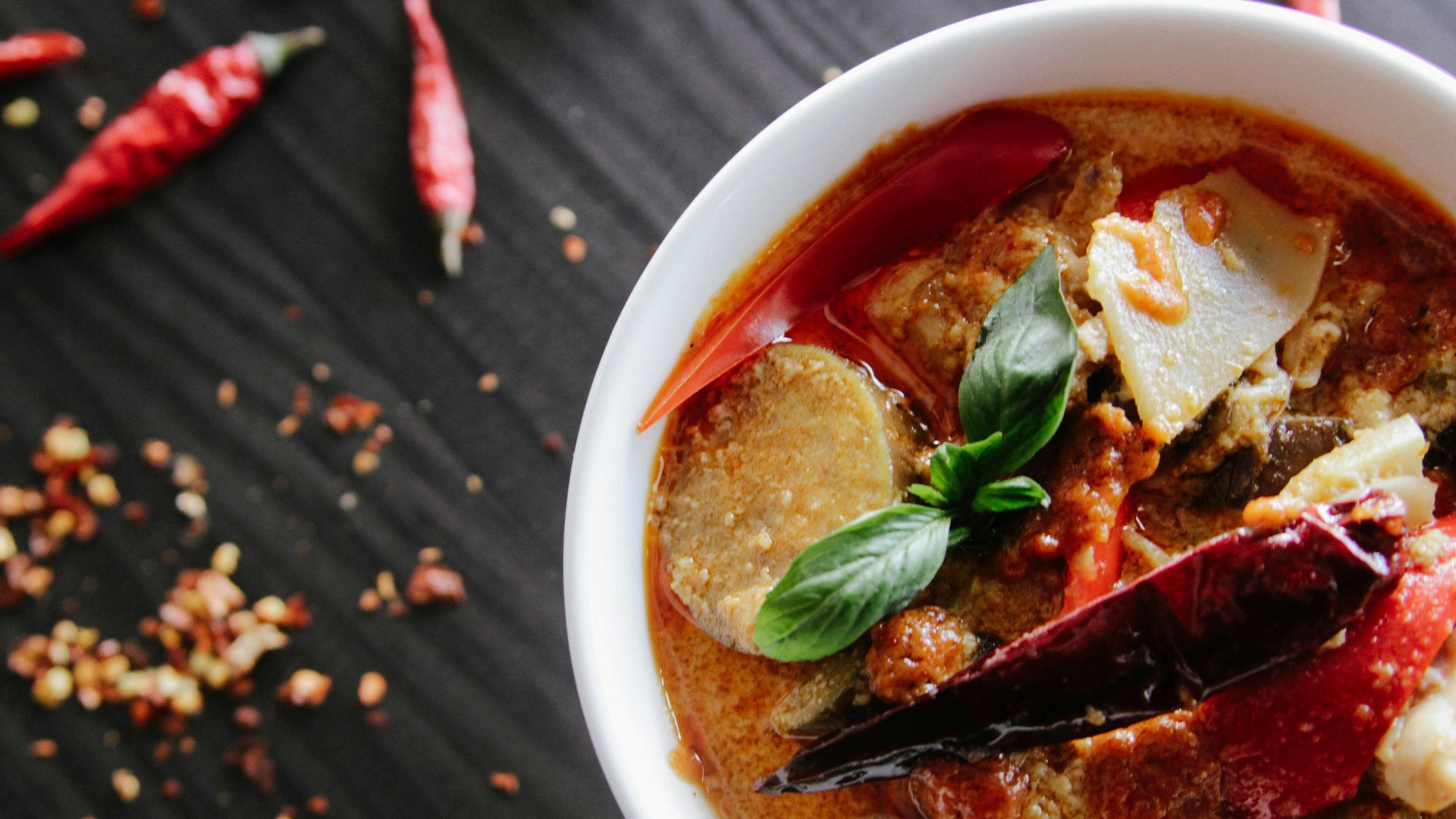 flat-lay photography of vegetable soup on white ceramic cup