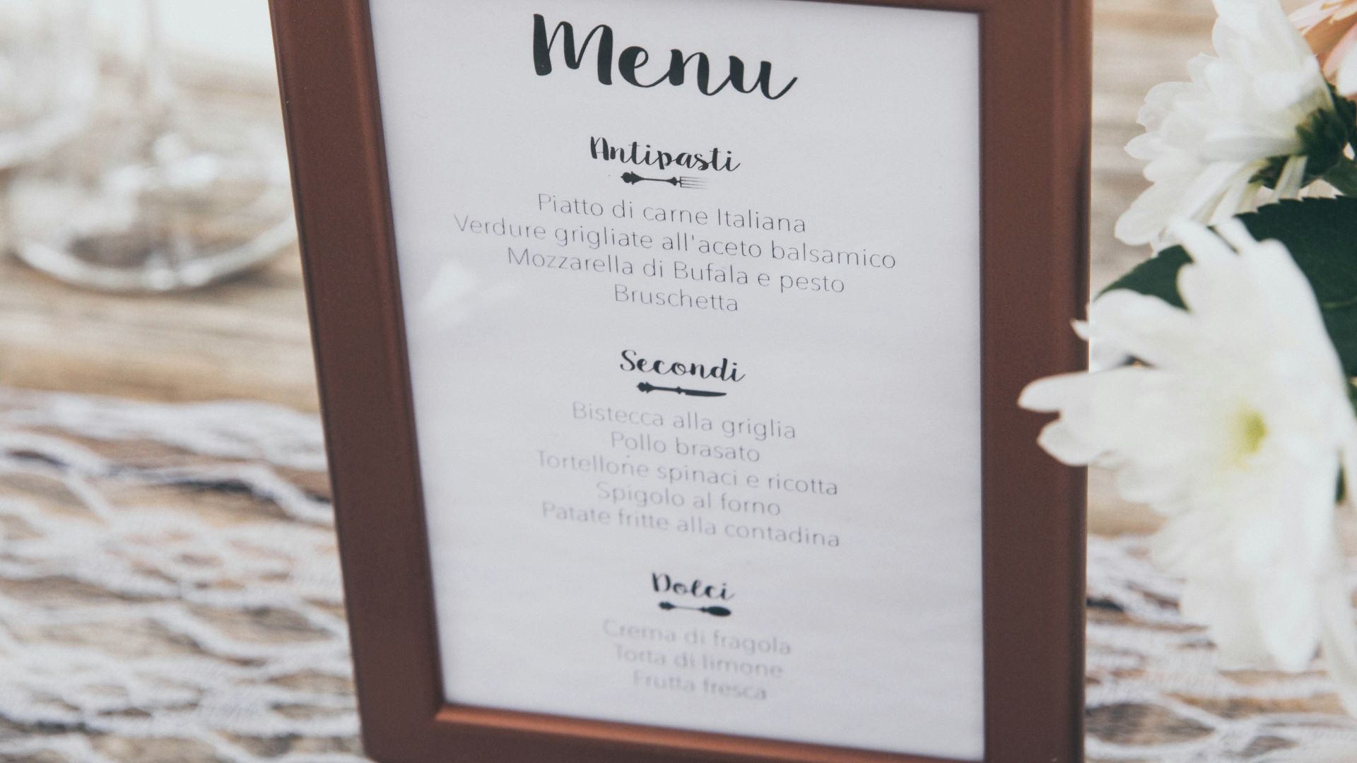 Menu-printed board with brown frame on table