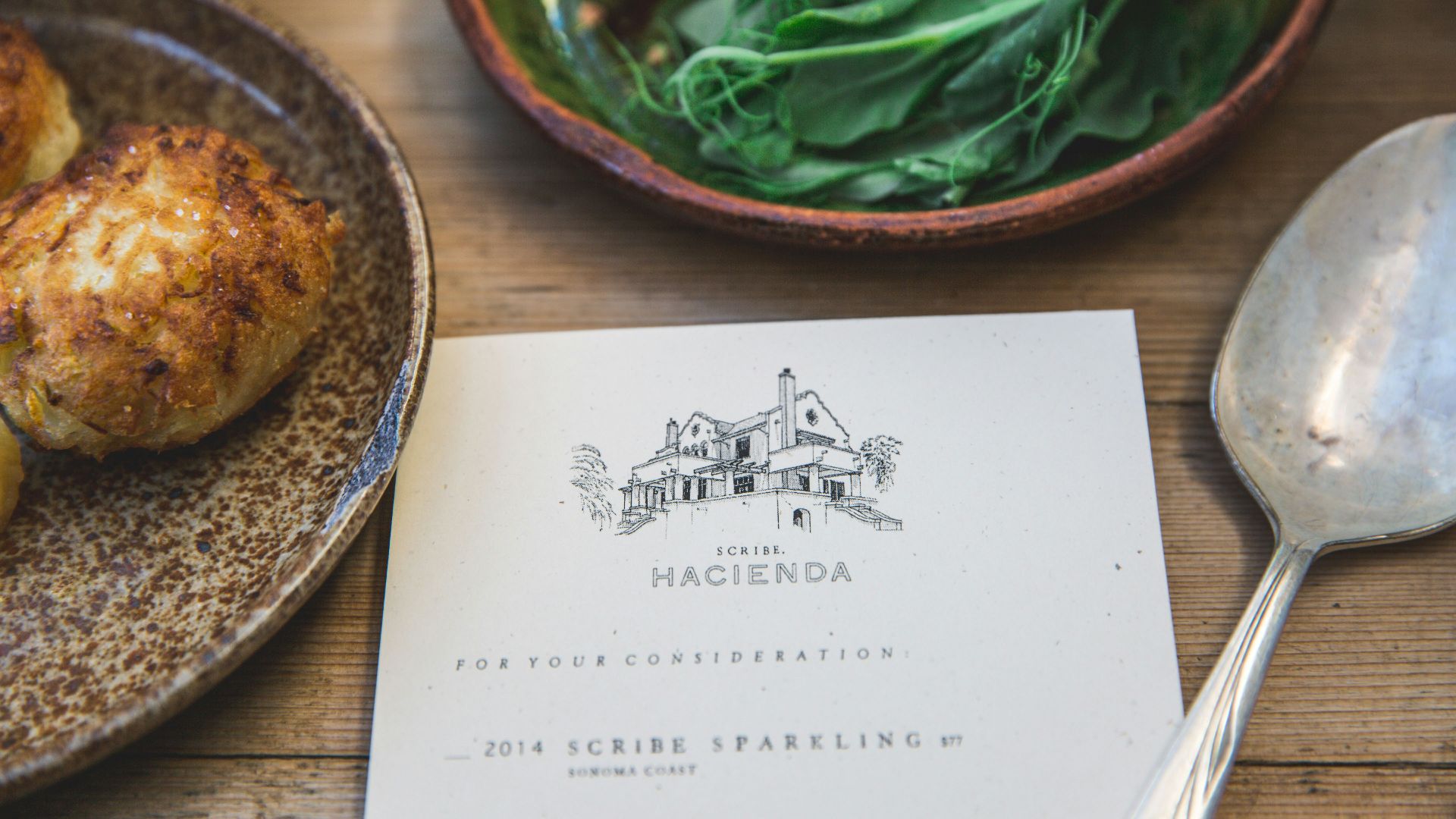 Hacienda book beside green vegetable on plate