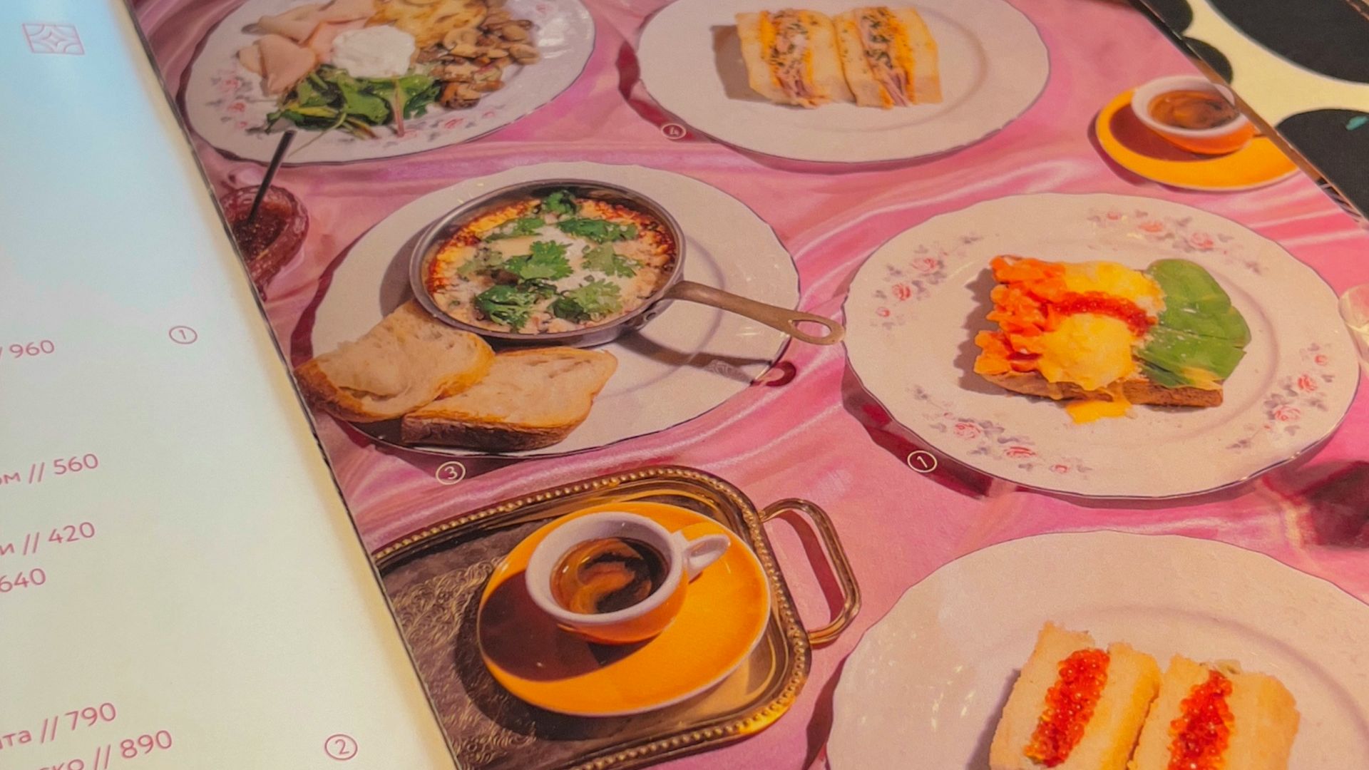 A table topped with plates of food and a menu