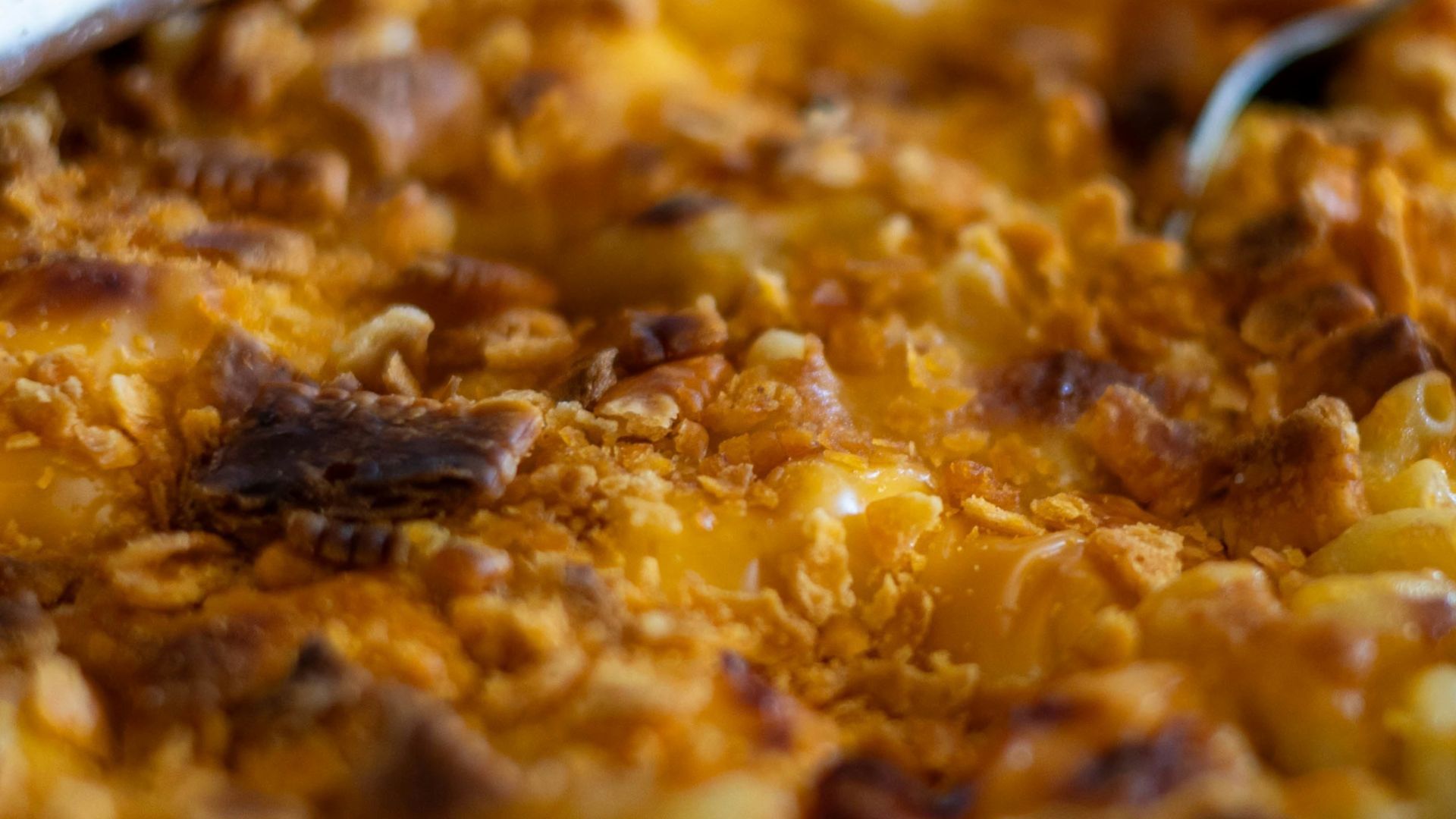 a dish of macaroni and cheese with a spoon in it