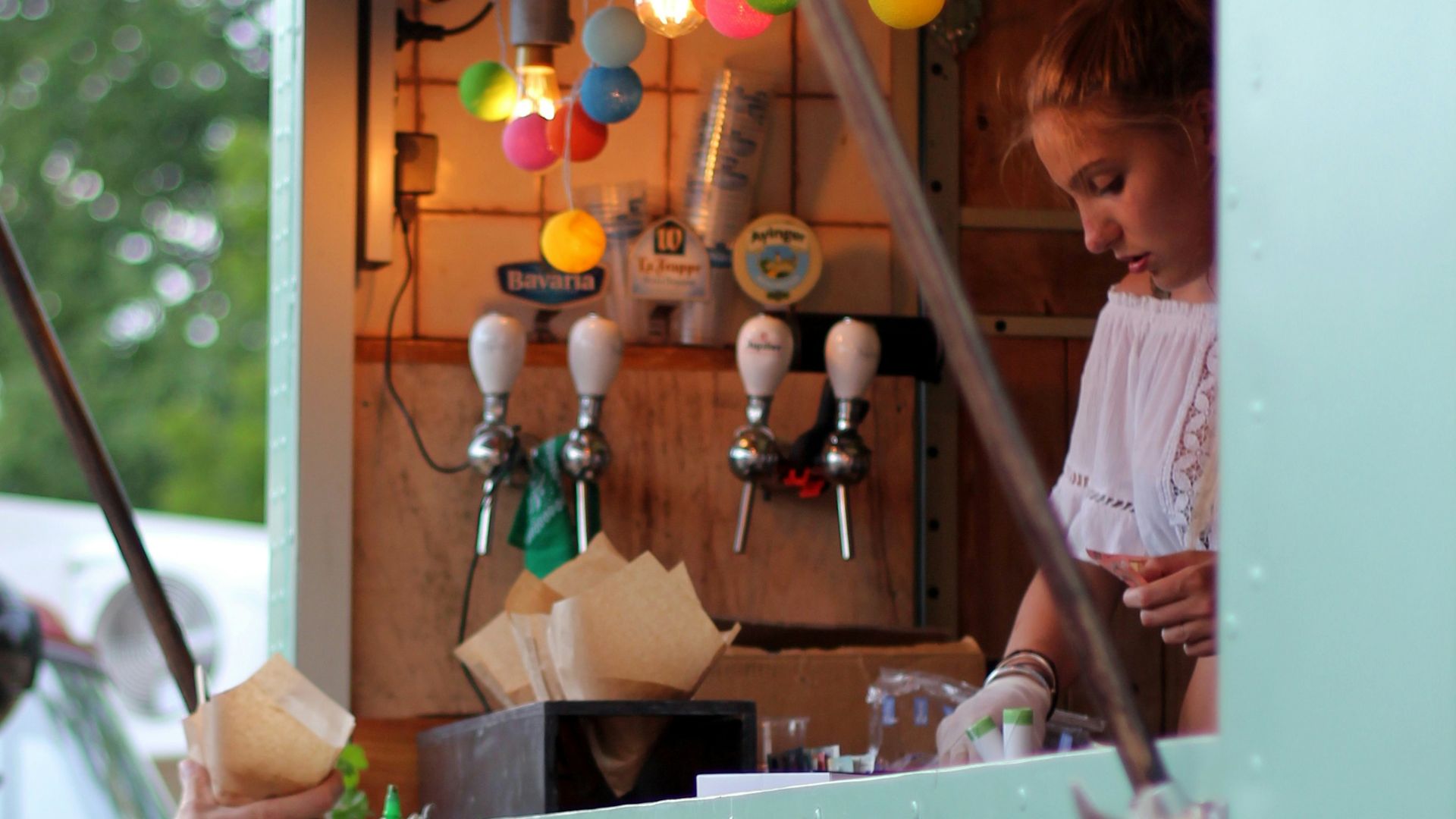 woman selling inside store during daytime