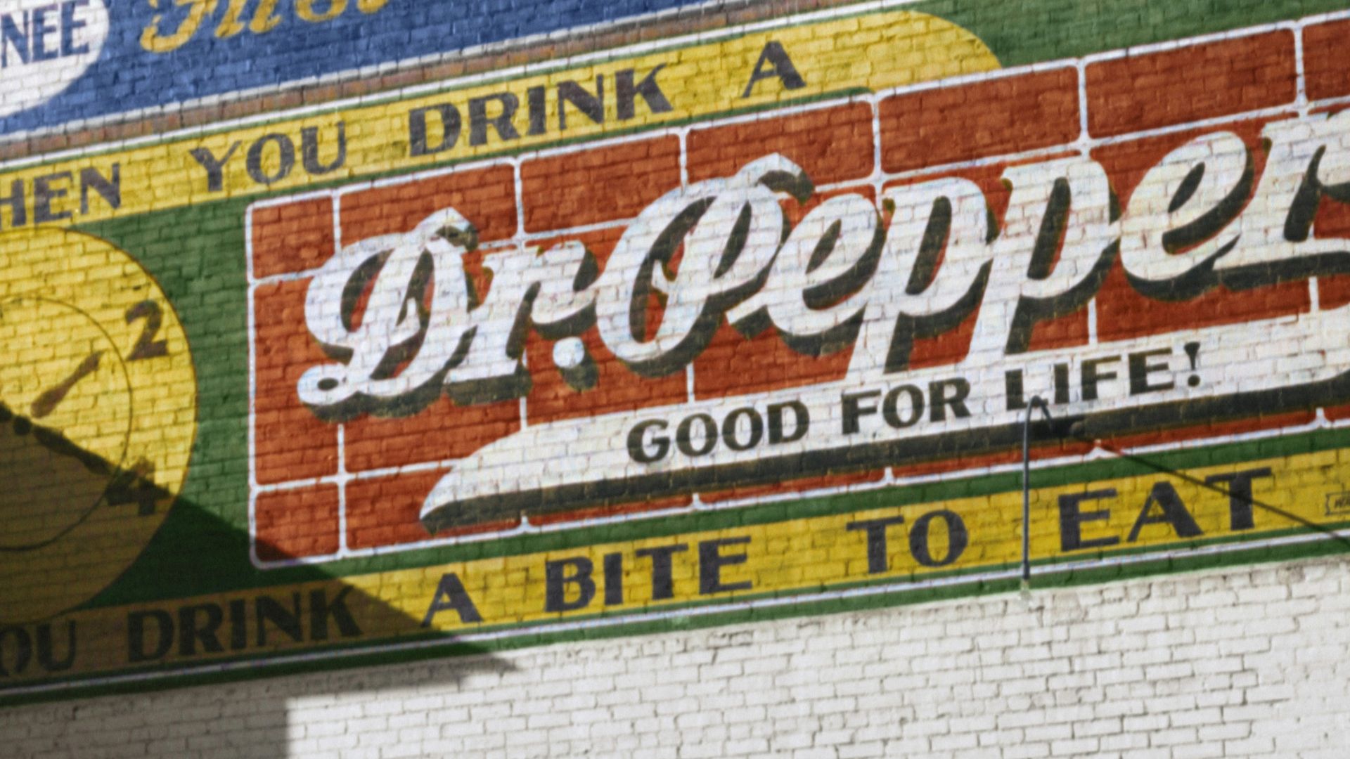 An African American man enters a movie theatre through the colored entrance