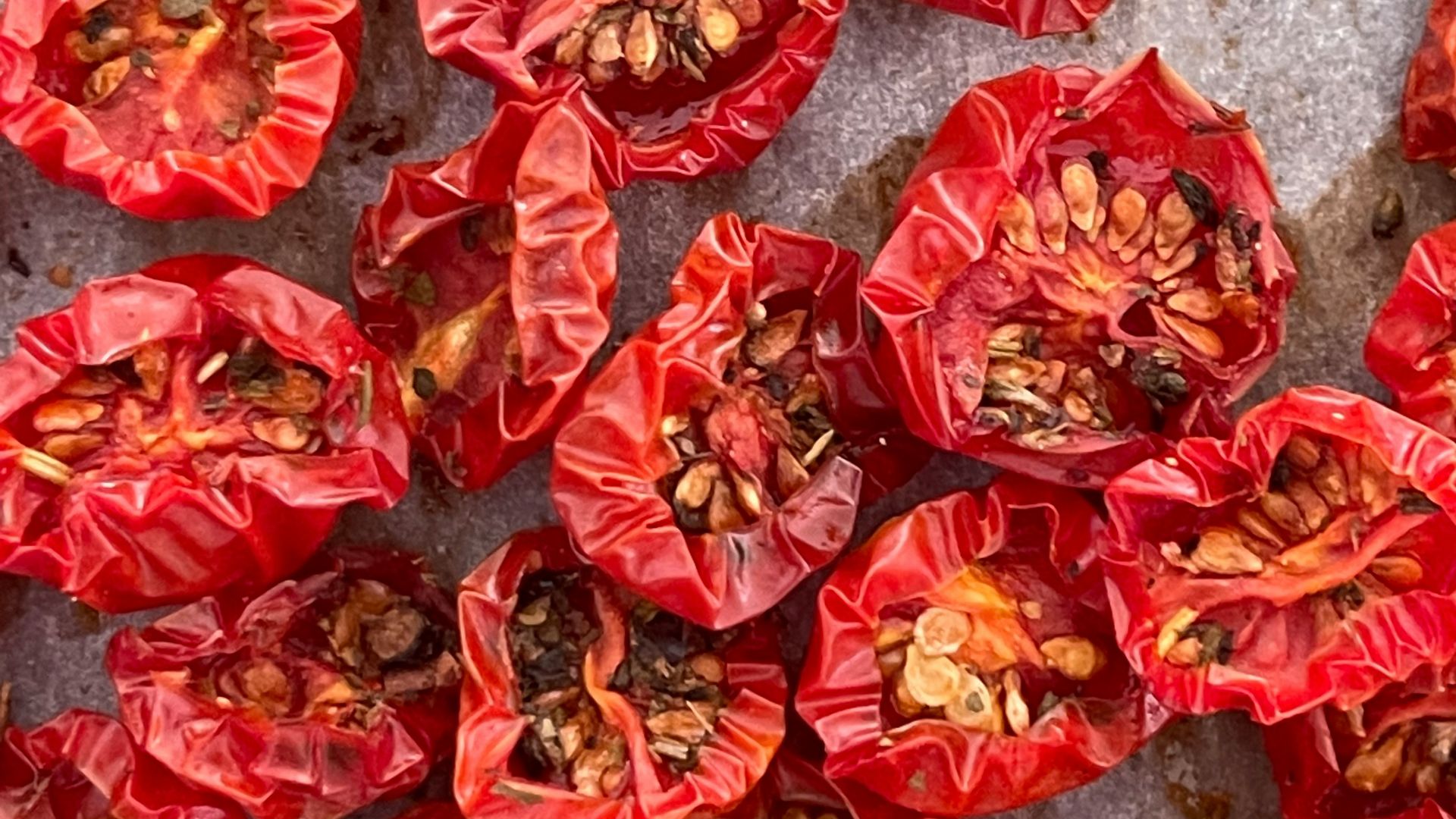 a bunch of red peppers sitting on top of a counter