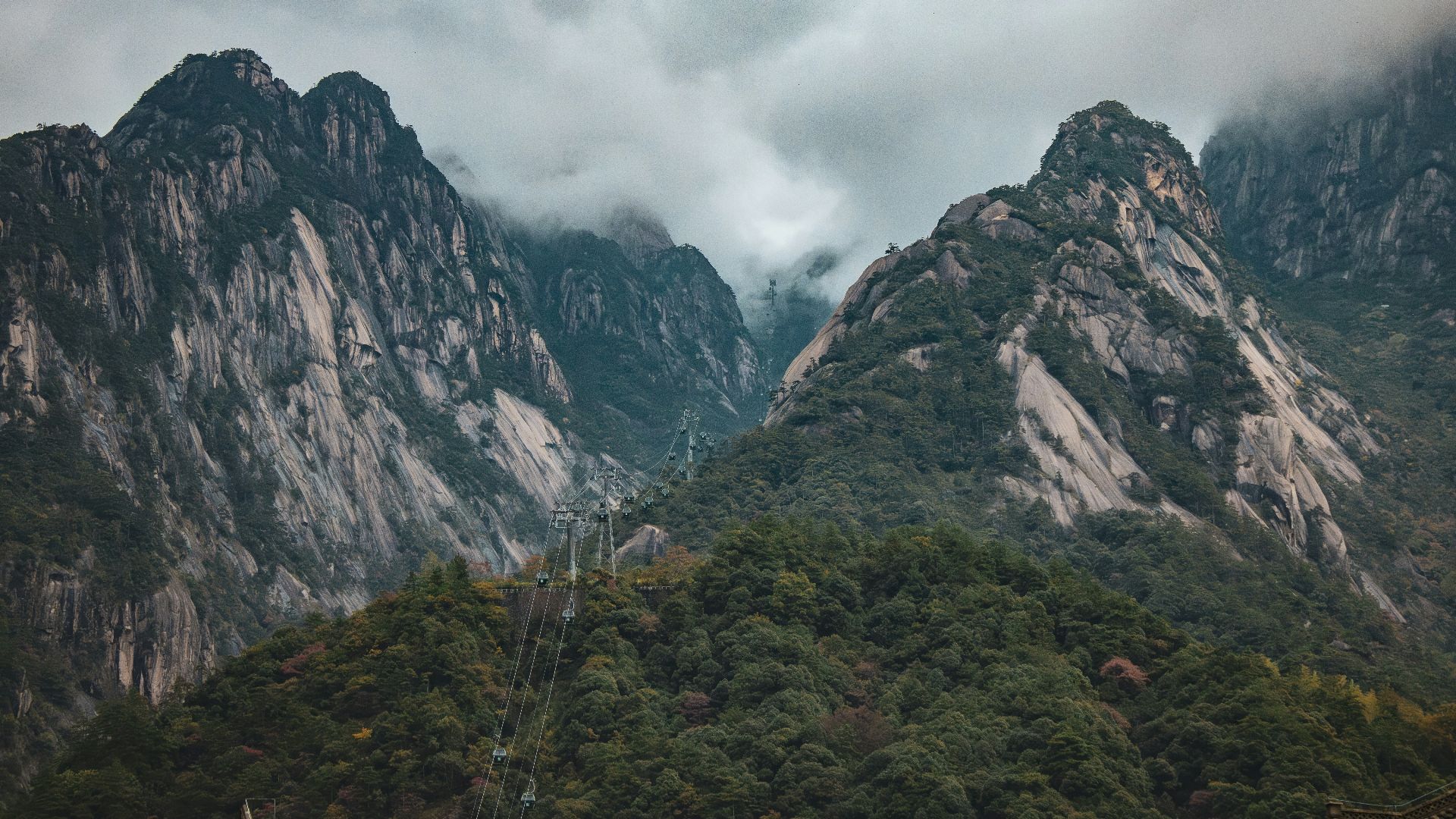 A boat floating on top of a lake surrounded by mountains