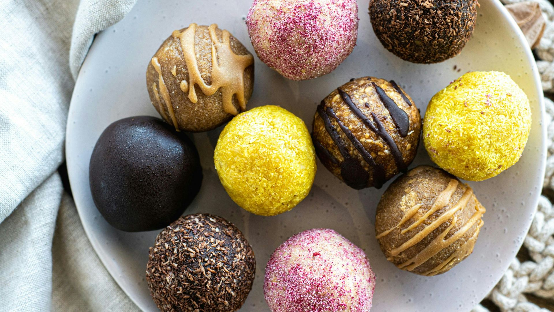 A white plate topped with different types of chocolates