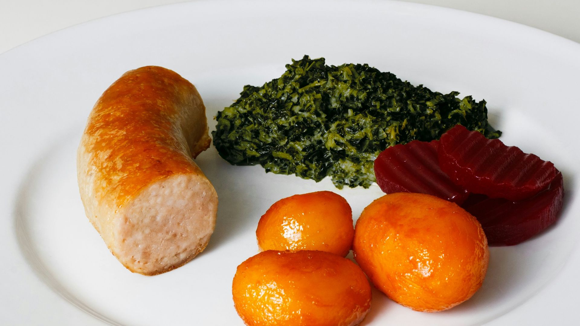 three orange fruits on white ceramic plate