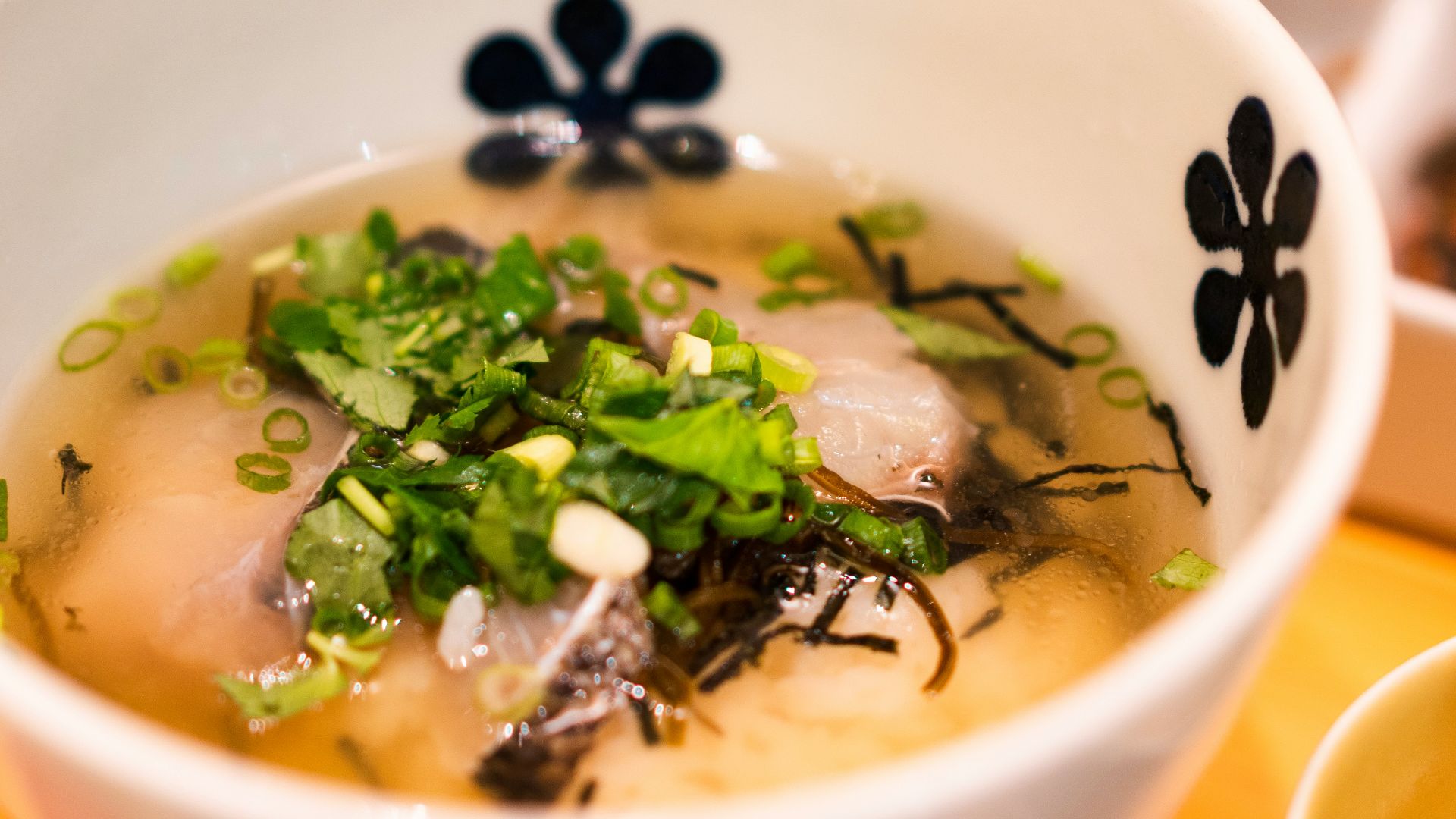 white and blue ceramic bowl with soup