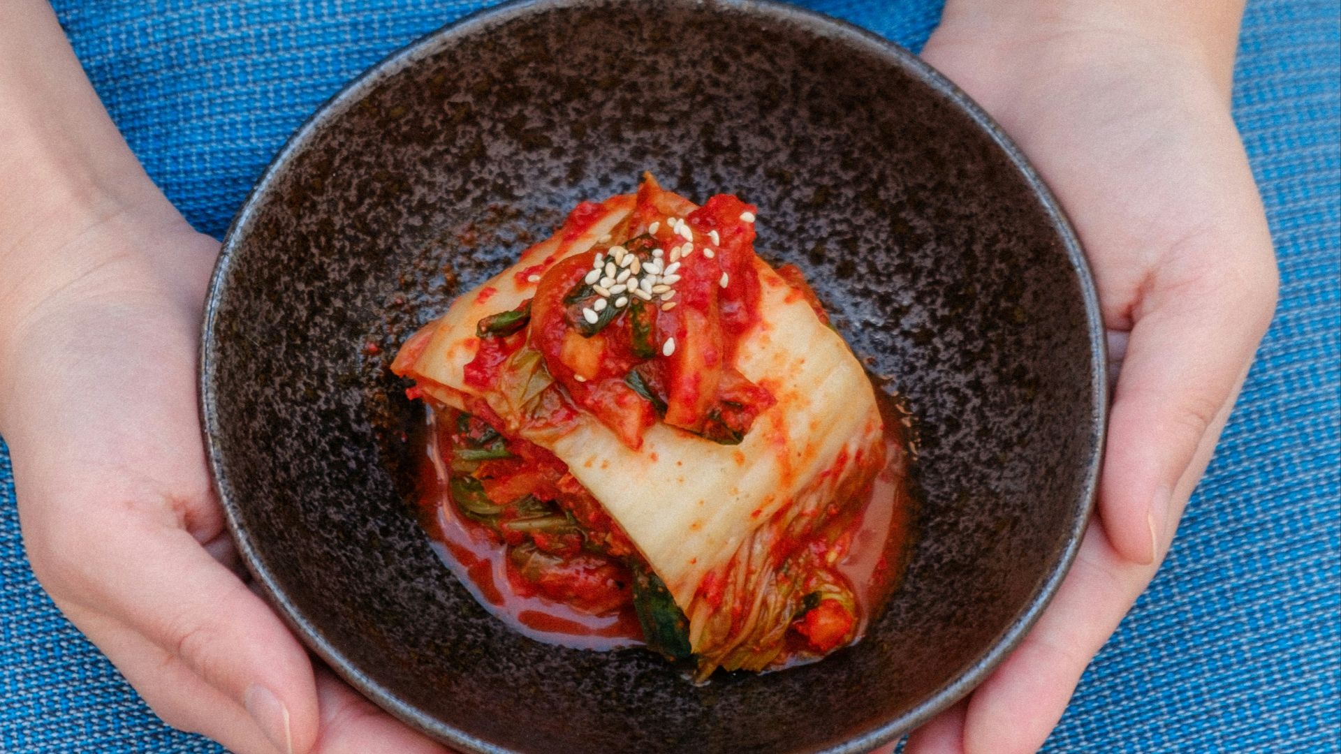 black ceramic bowl on blue textile