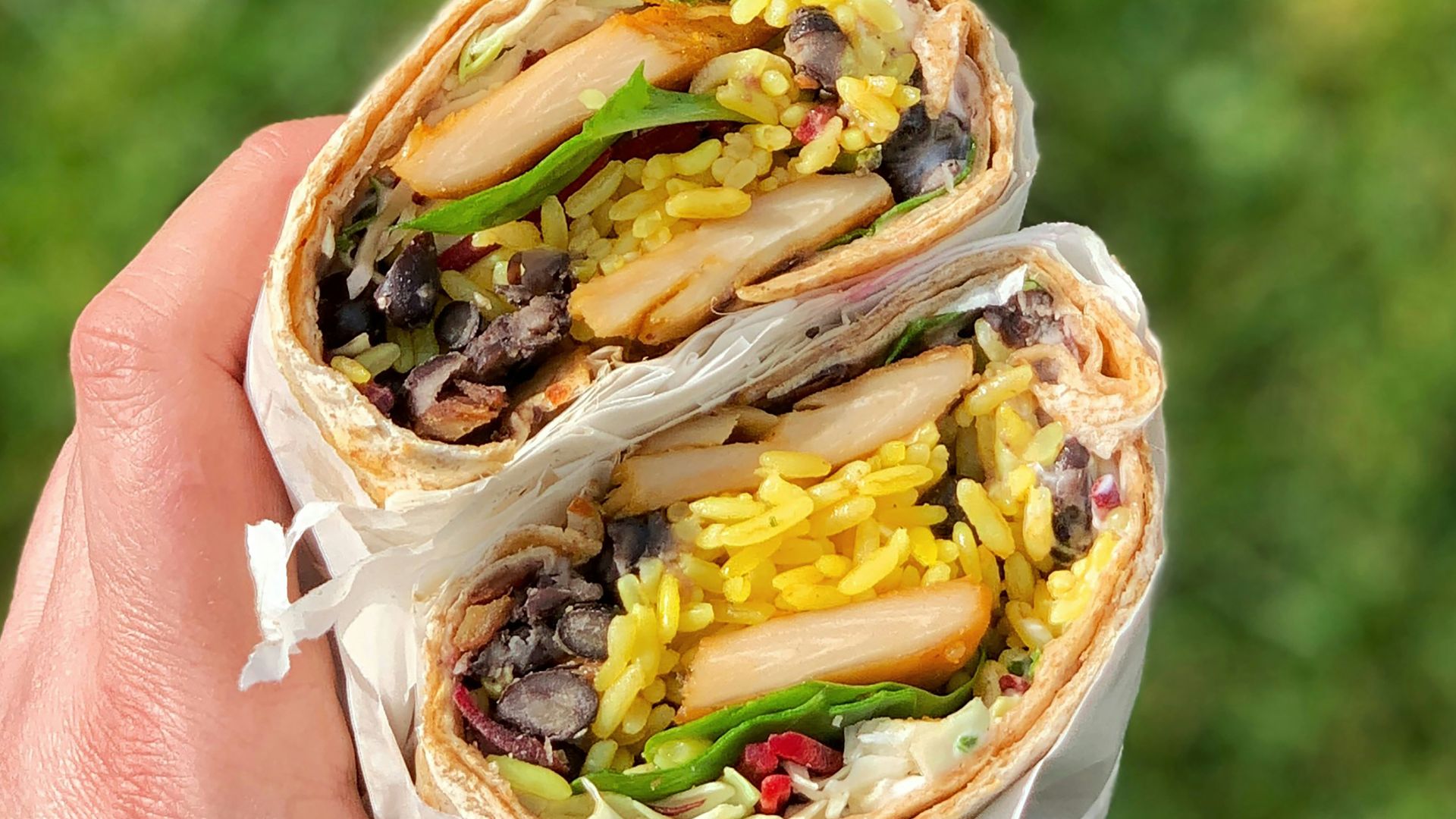 person holding a white and brown cake