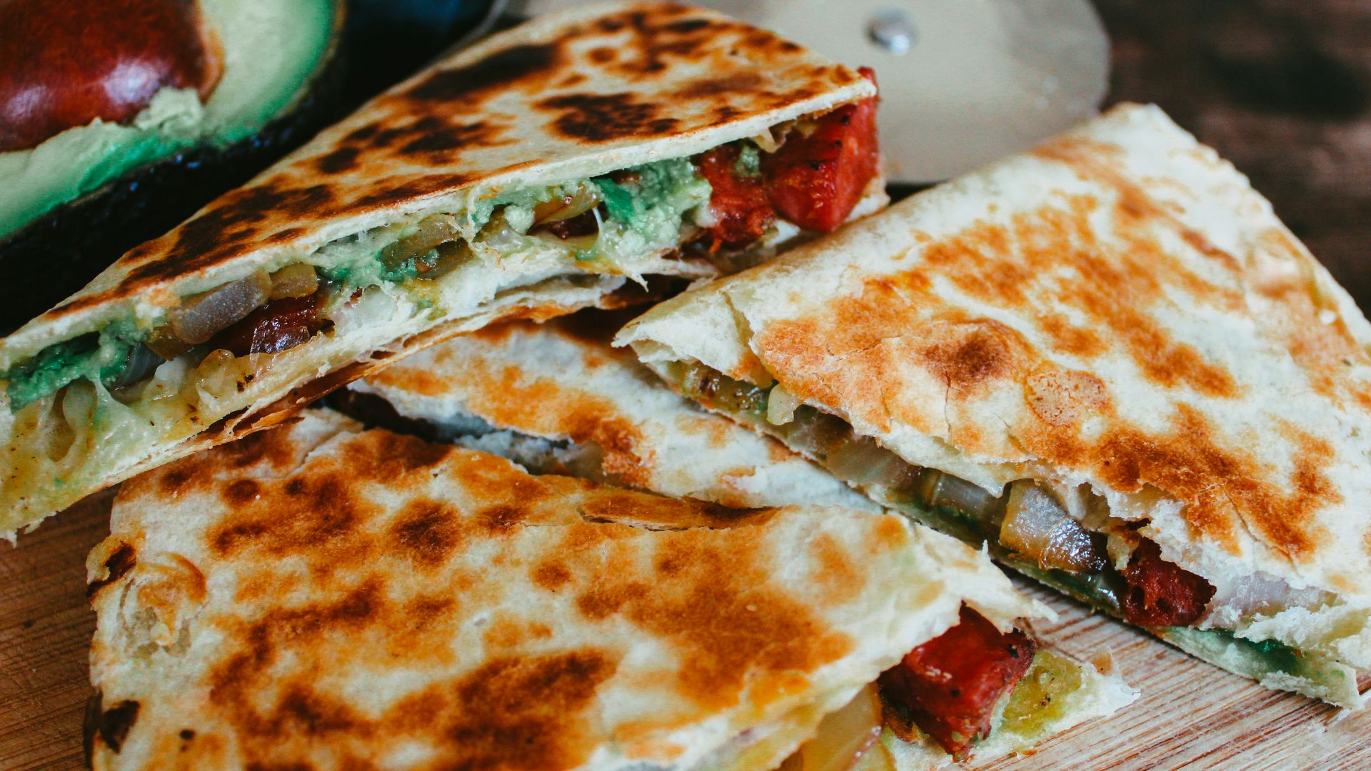 sliced pizza on brown wooden table