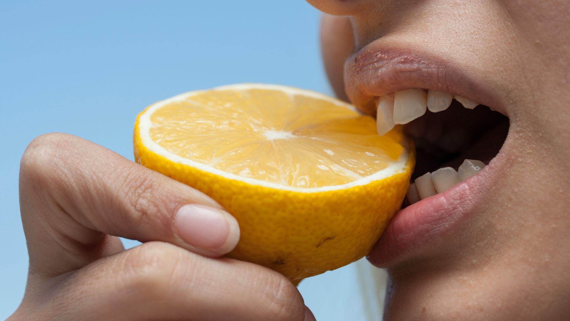 person holding orange fruit during daytime