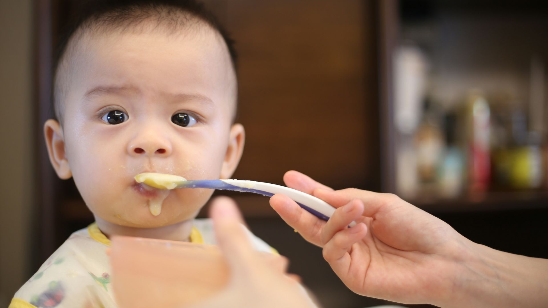 person feeding baby