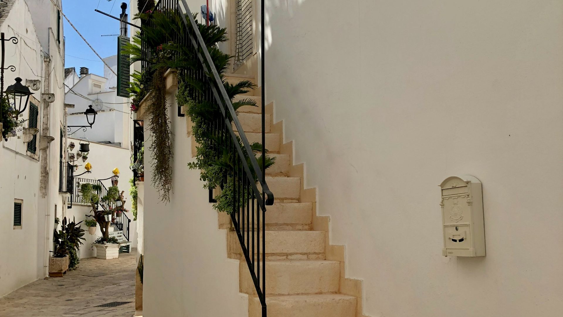 a white building with a stair case next to it