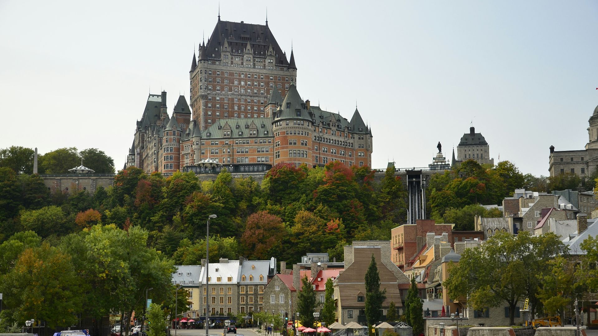 cars parked near brown and gray concrete building during daytime