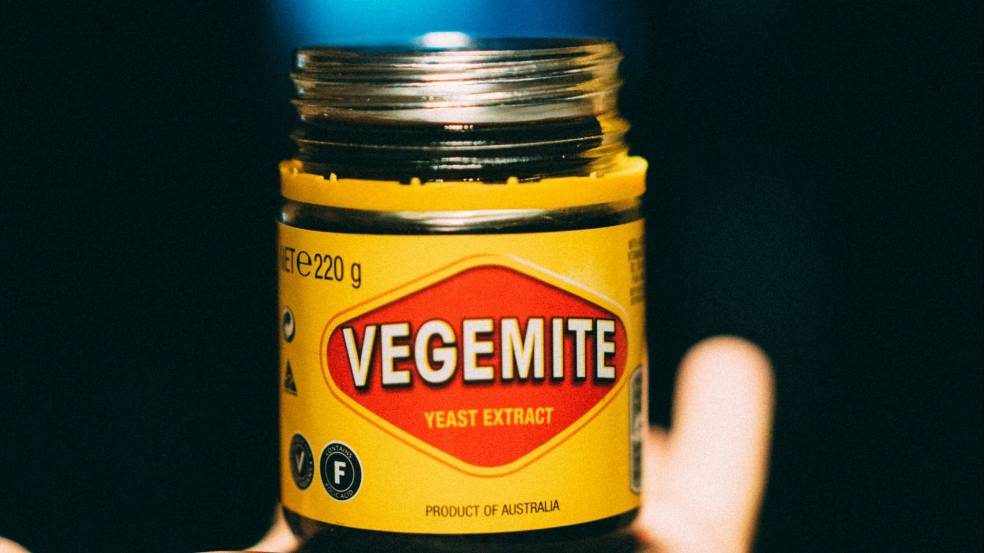 person holding yellow and black bottle