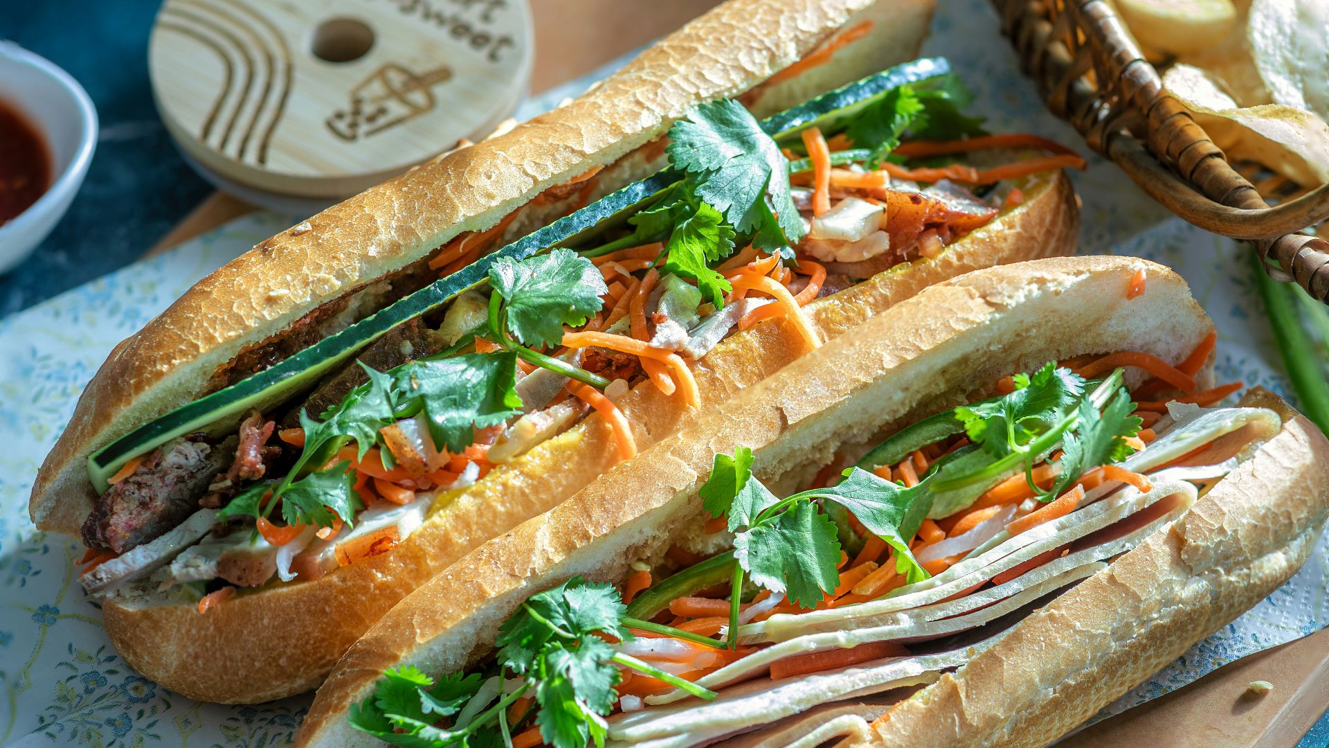 a couple of sandwiches sitting on top of a cutting board