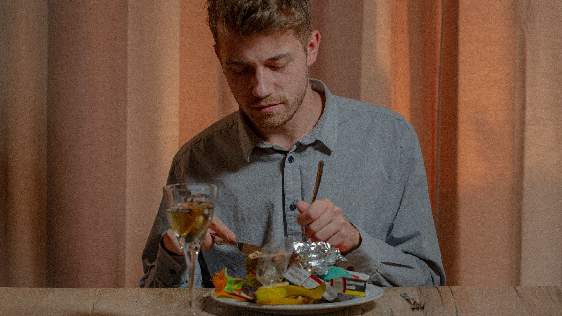man in gray dress shirt sitting on chair