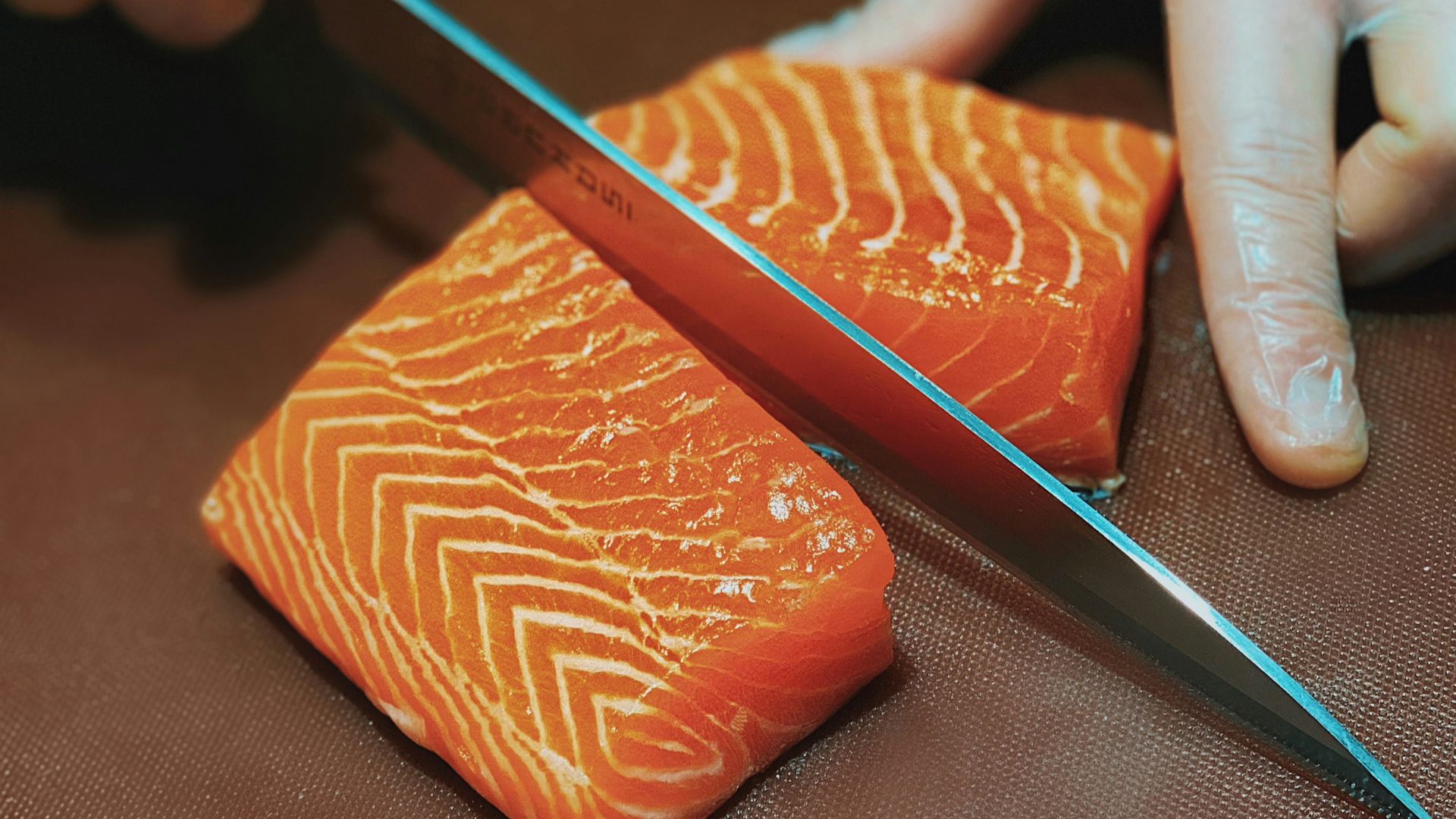 person holding black pencil and brown leather case