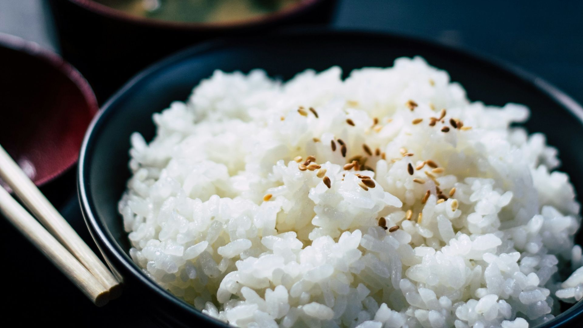 rice with sesame in black bowl