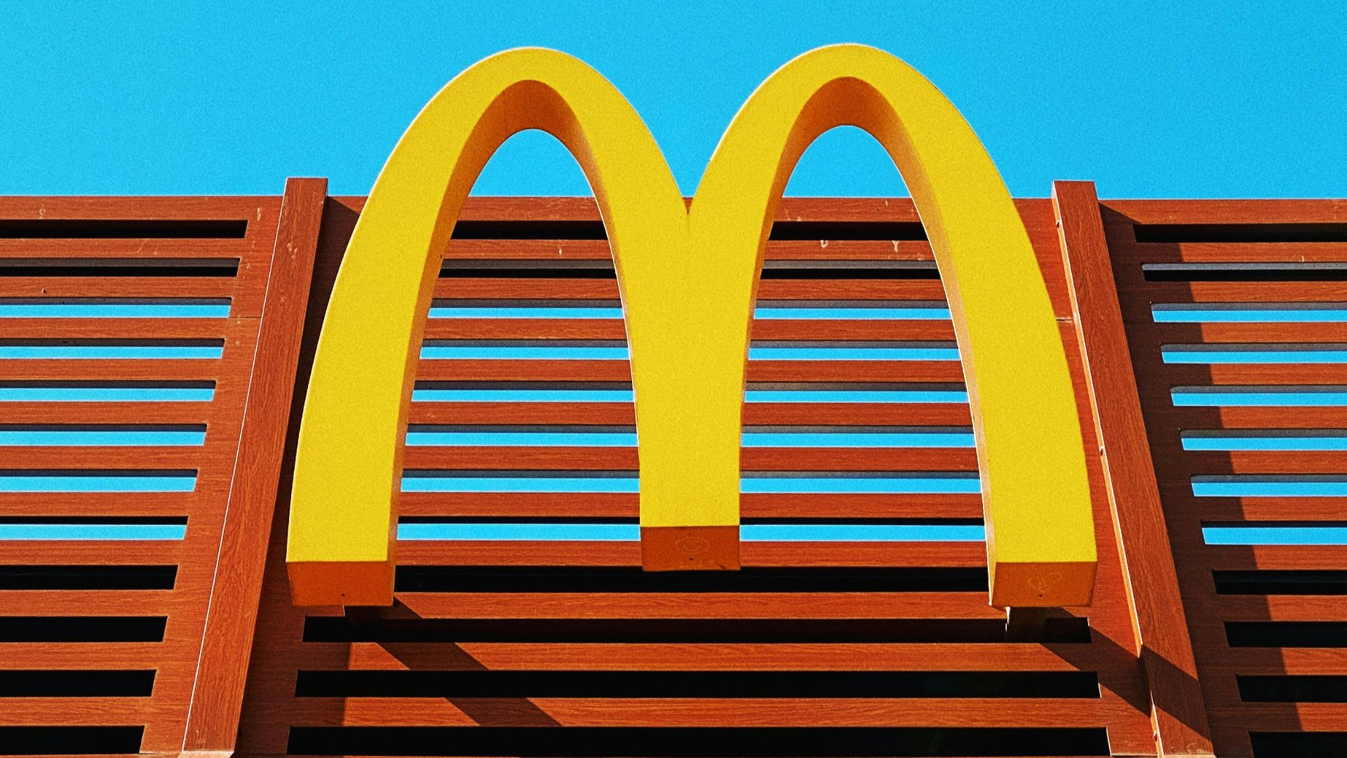 a wooden bench with a mcdonald's logo on it