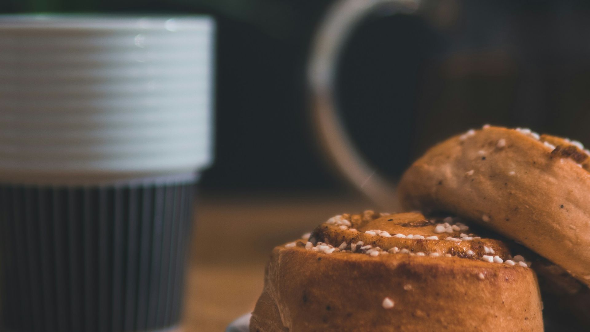 pastry bread with spoon beside and cup