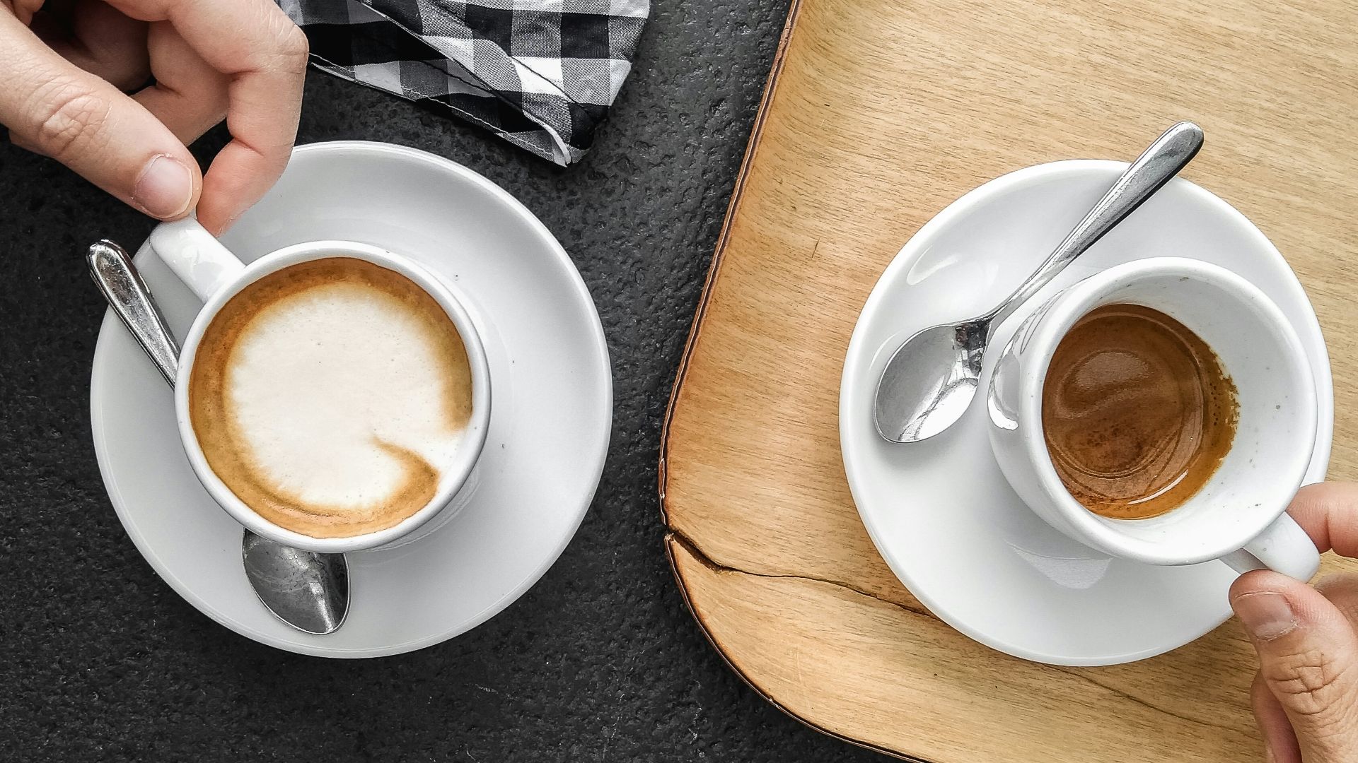 person holding white ceramic mug with brown liquid