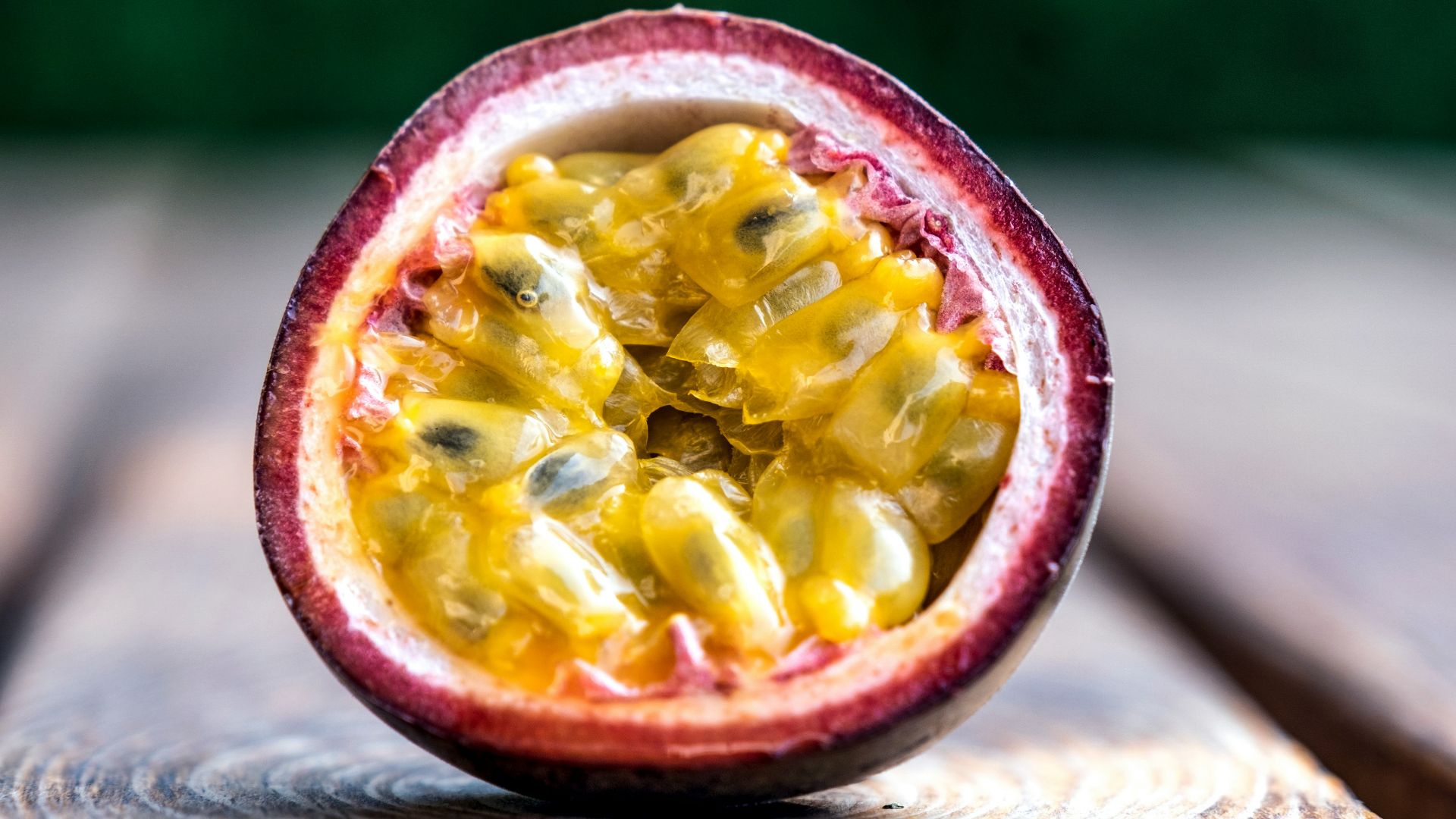 red and yellow round fruit on brown wooden table