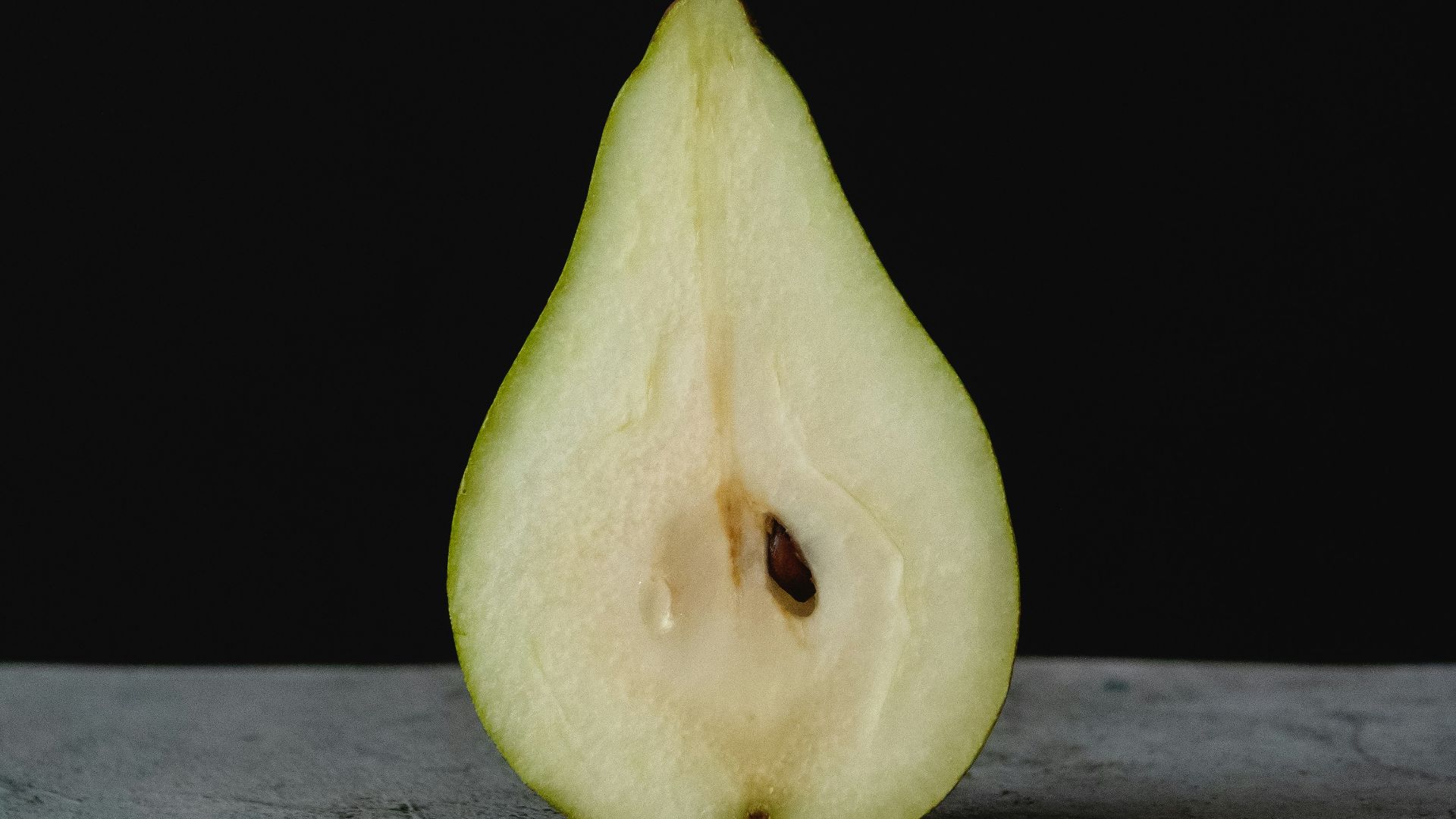 green fruit on gray wooden table