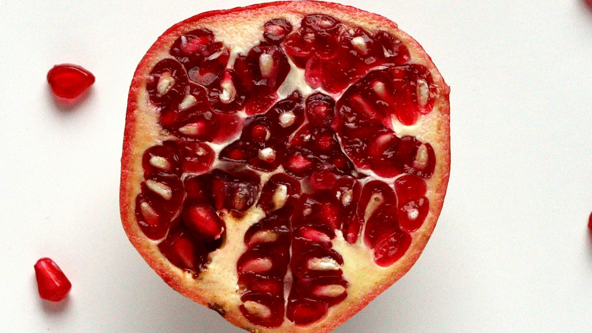 red sliced fruit on white surface