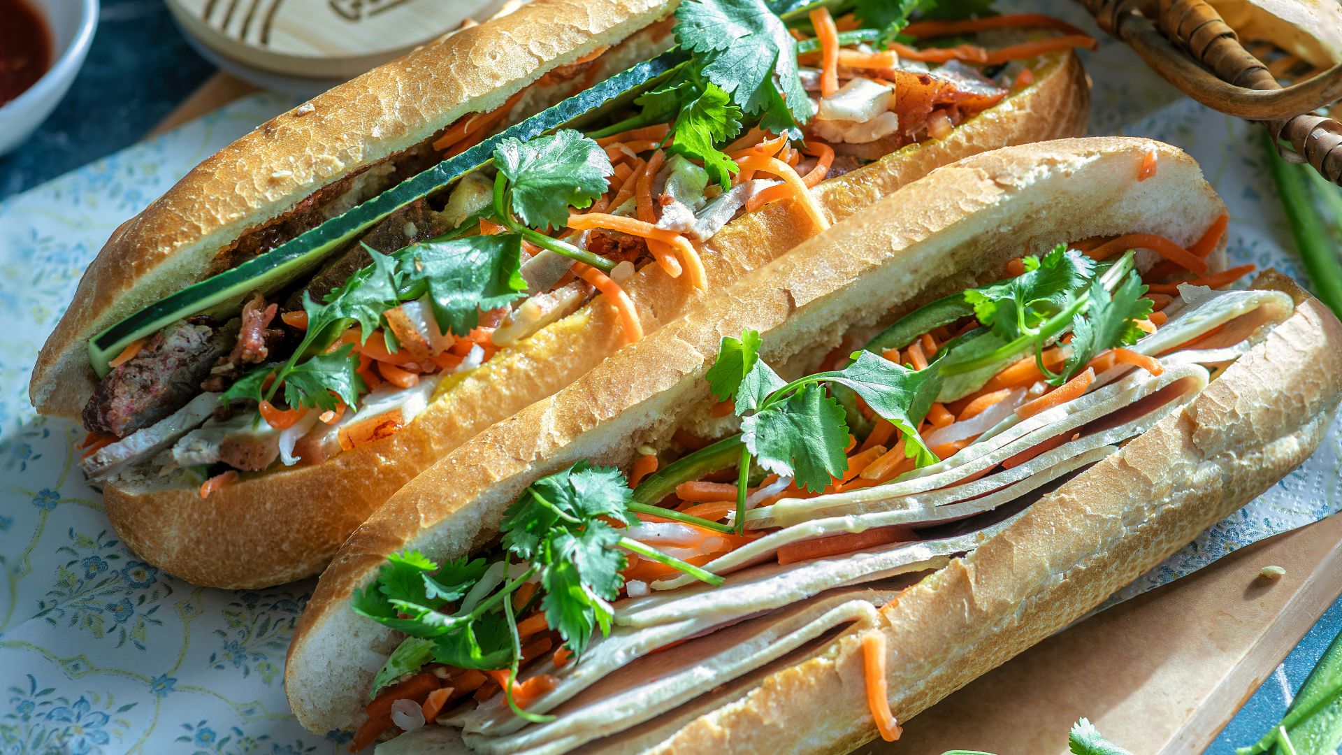 a couple of sandwiches sitting on top of a cutting board