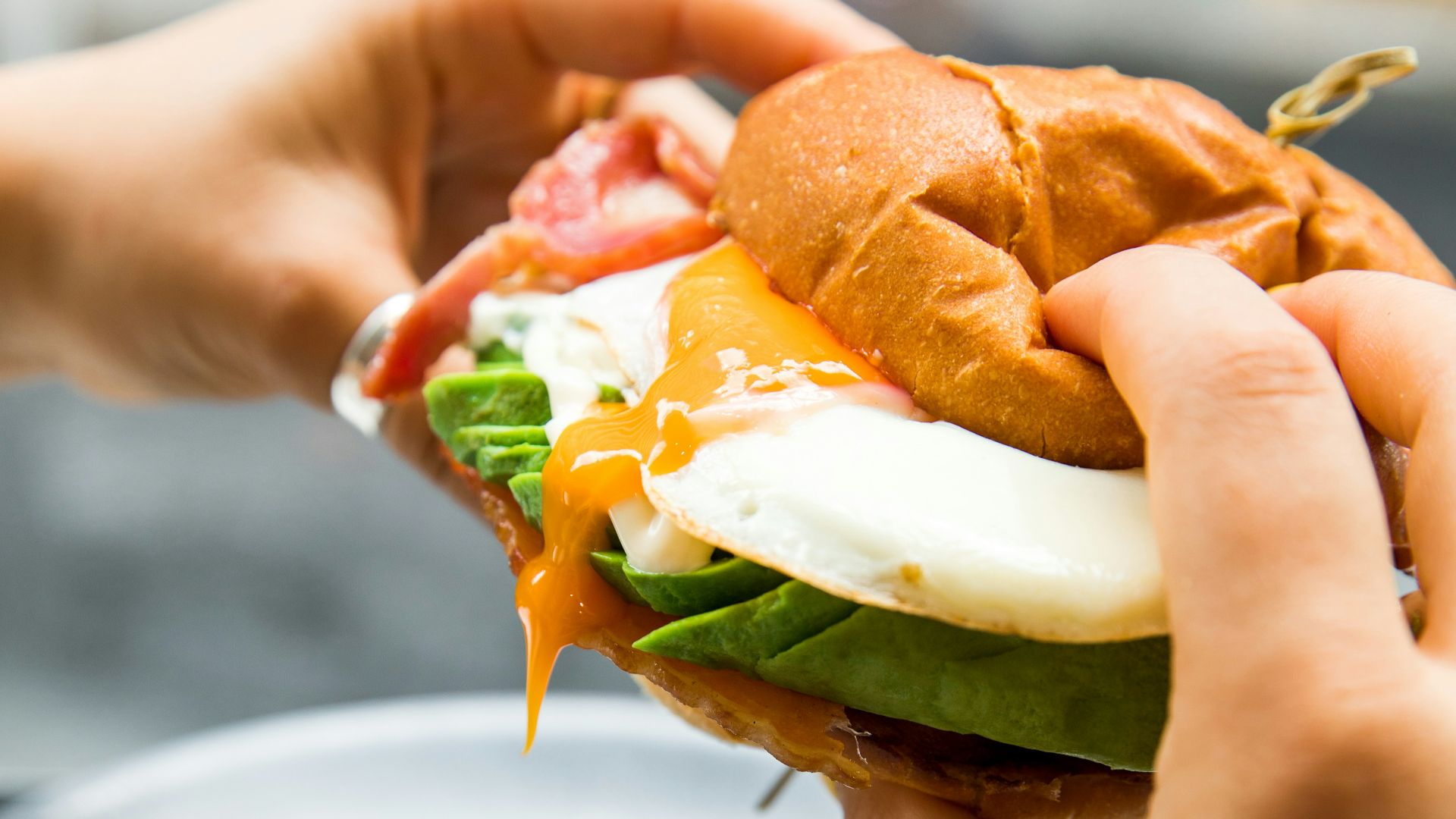 burger with lettuce and tomato on white ceramic plate