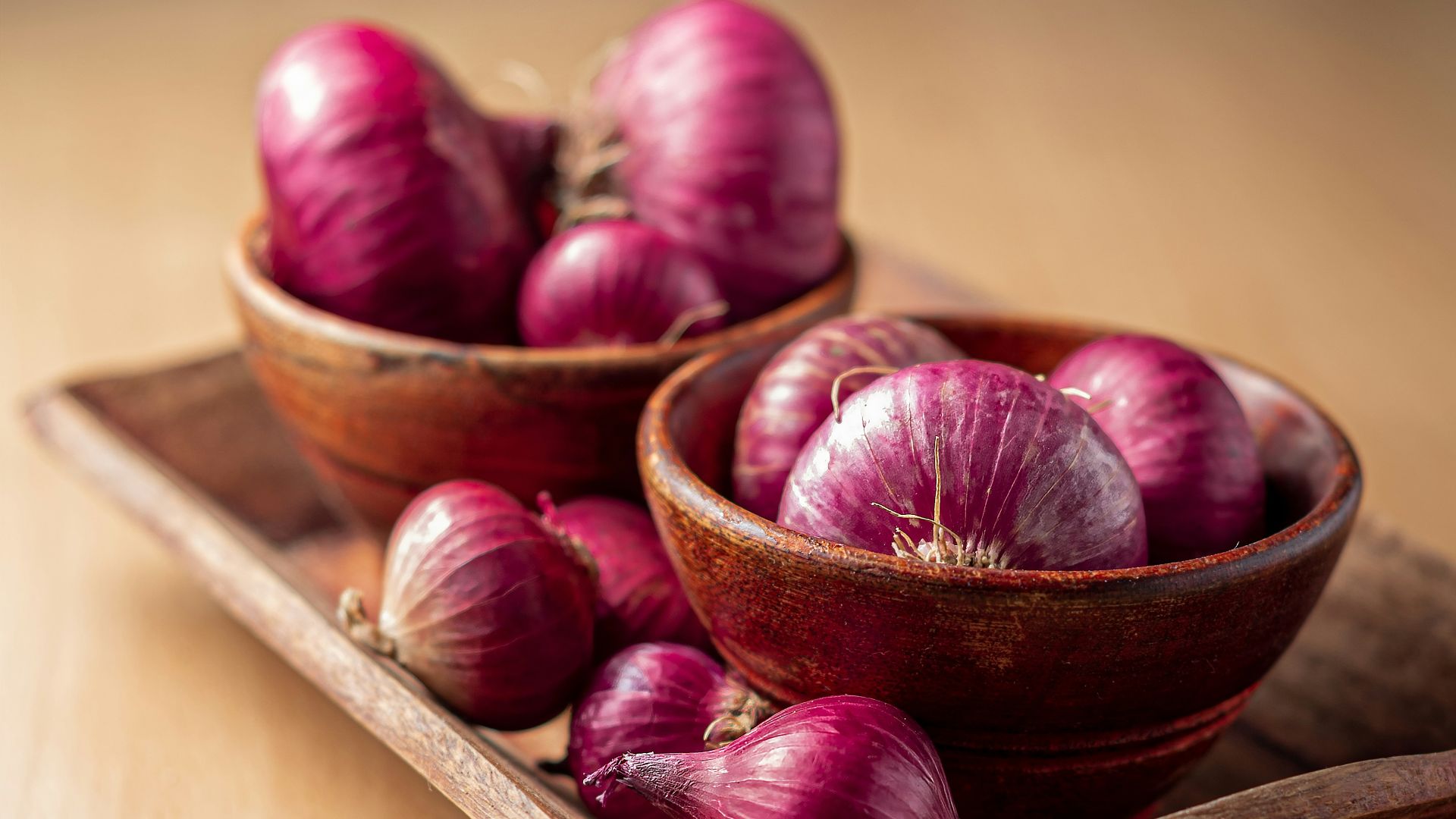red onion on brown wooden tray