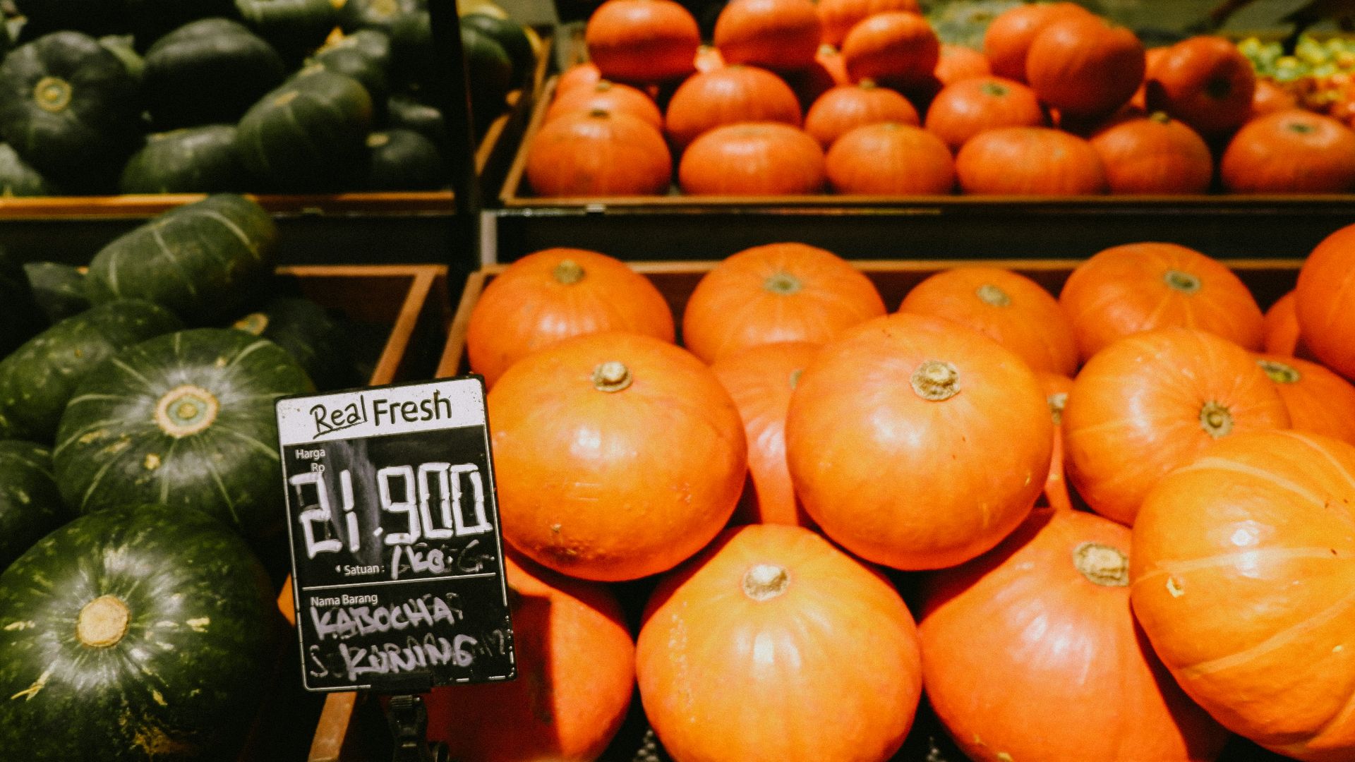 orange pumpkins on brown wooden crate