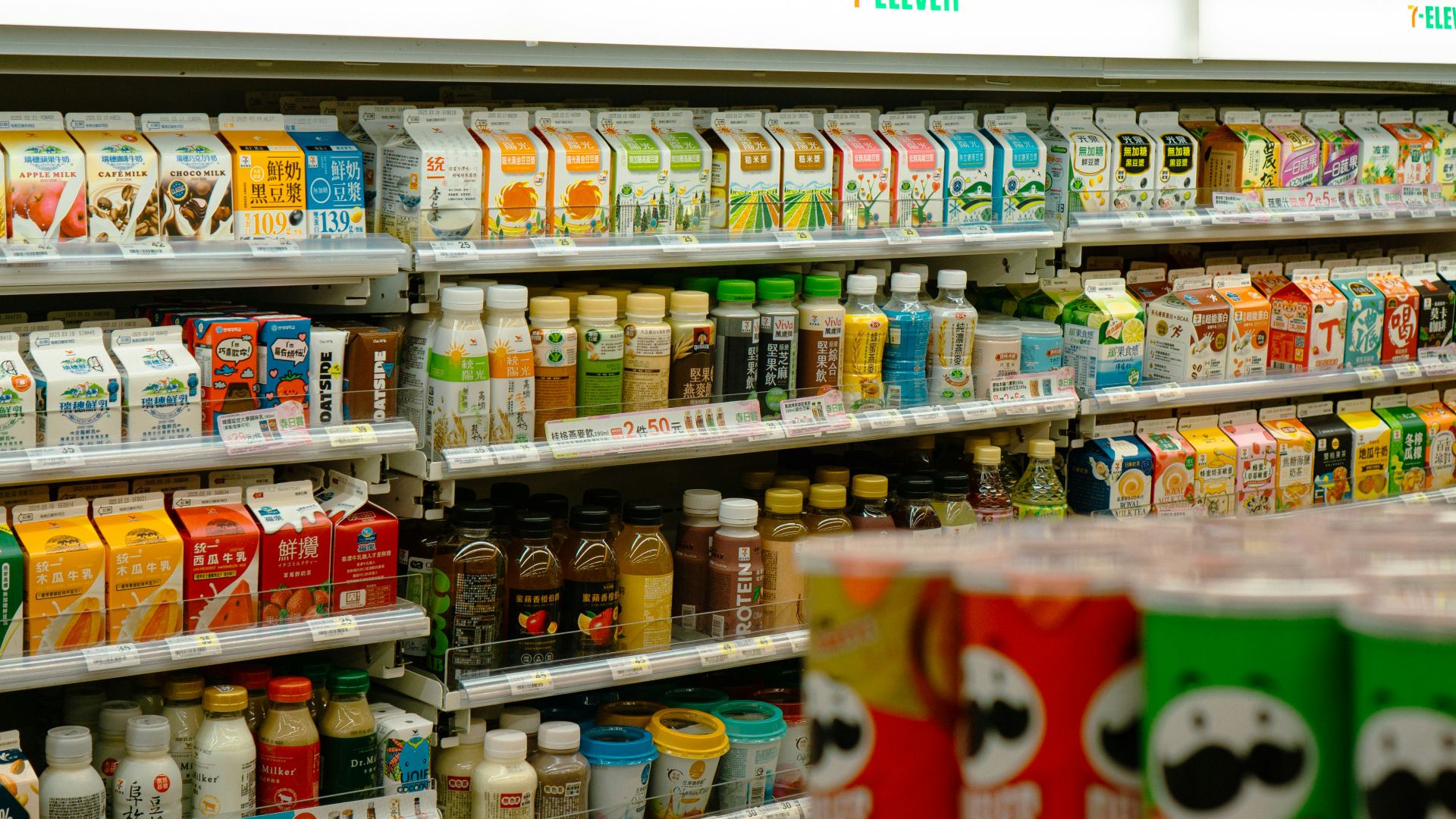 Shelves of snacks and drinks inside a 7-eleven.