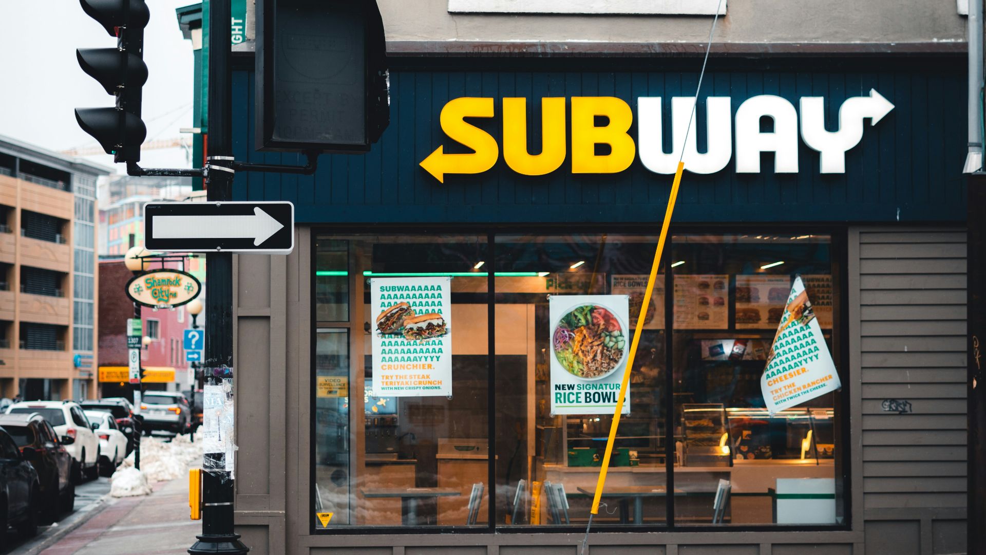 a subway restaurant on a city street corner
