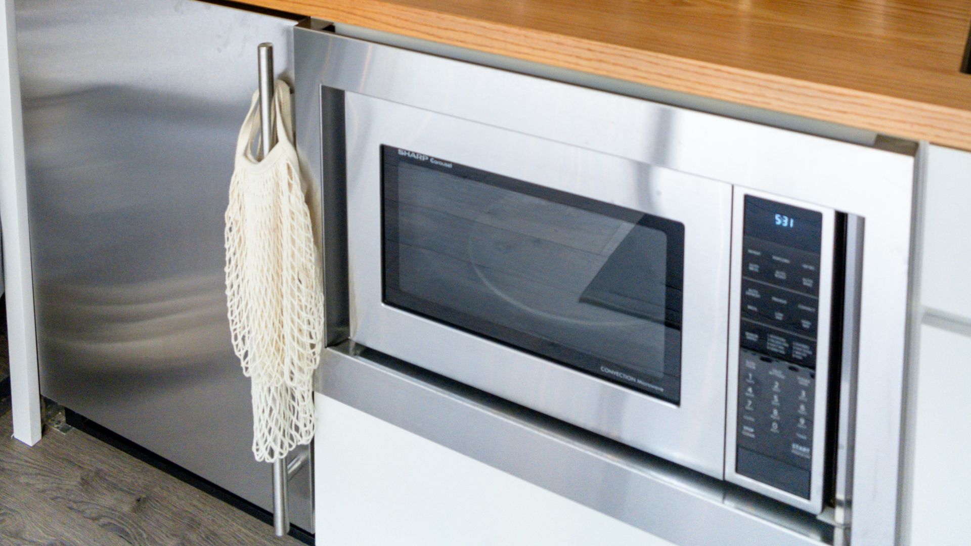 a kitchen counter with a microwave and a potted plant
