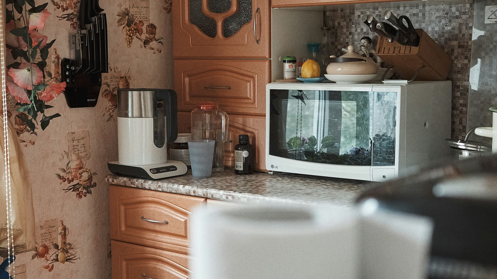 white microwave oven on brown wooden cabinet