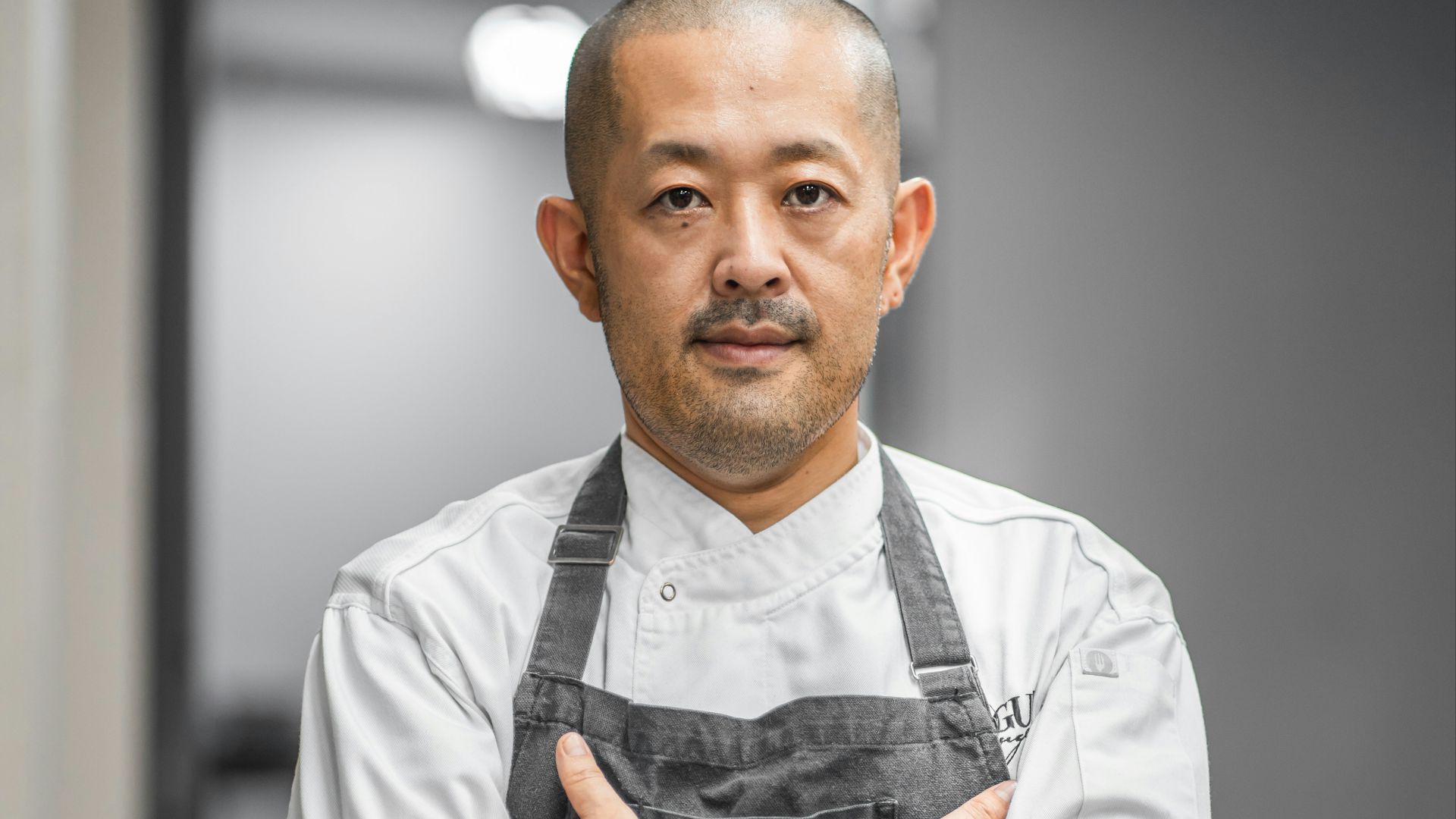 man in white button up shirt and black vest
