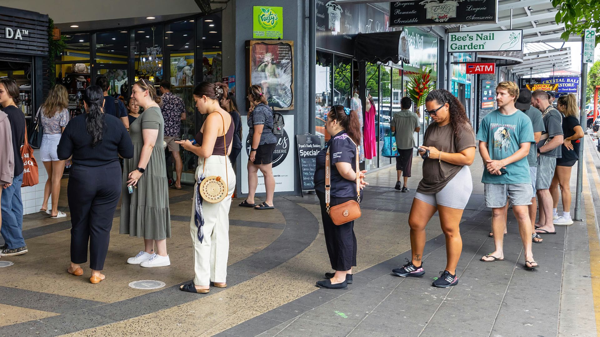 a group of people standing outside of a store