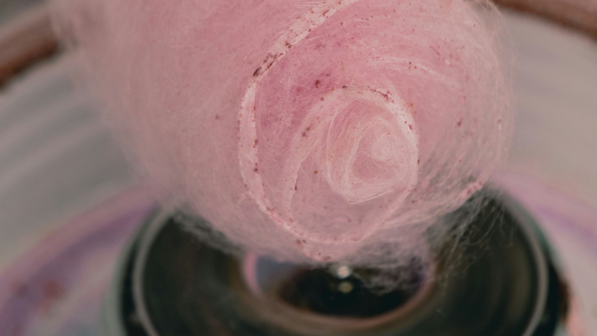 a pink ball of yarn is in a bowl