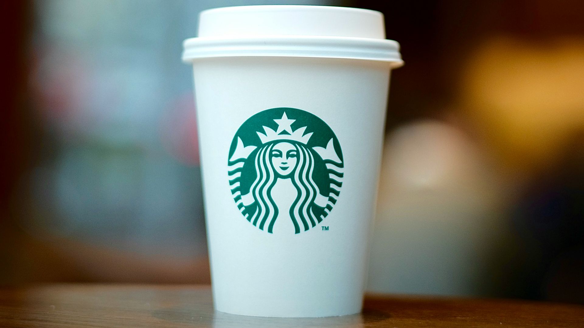 white and green starbucks disposable cup