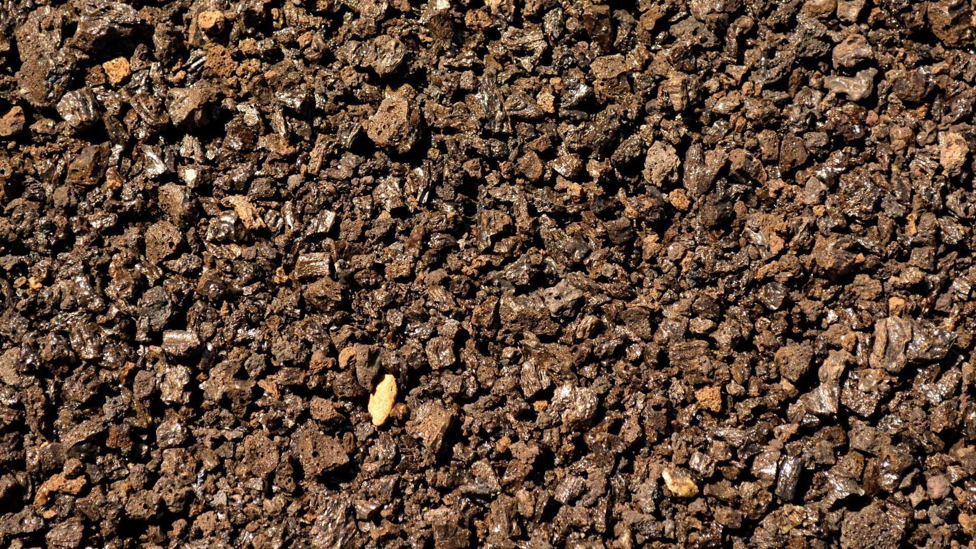 a close up of a dirt surface with small rocks