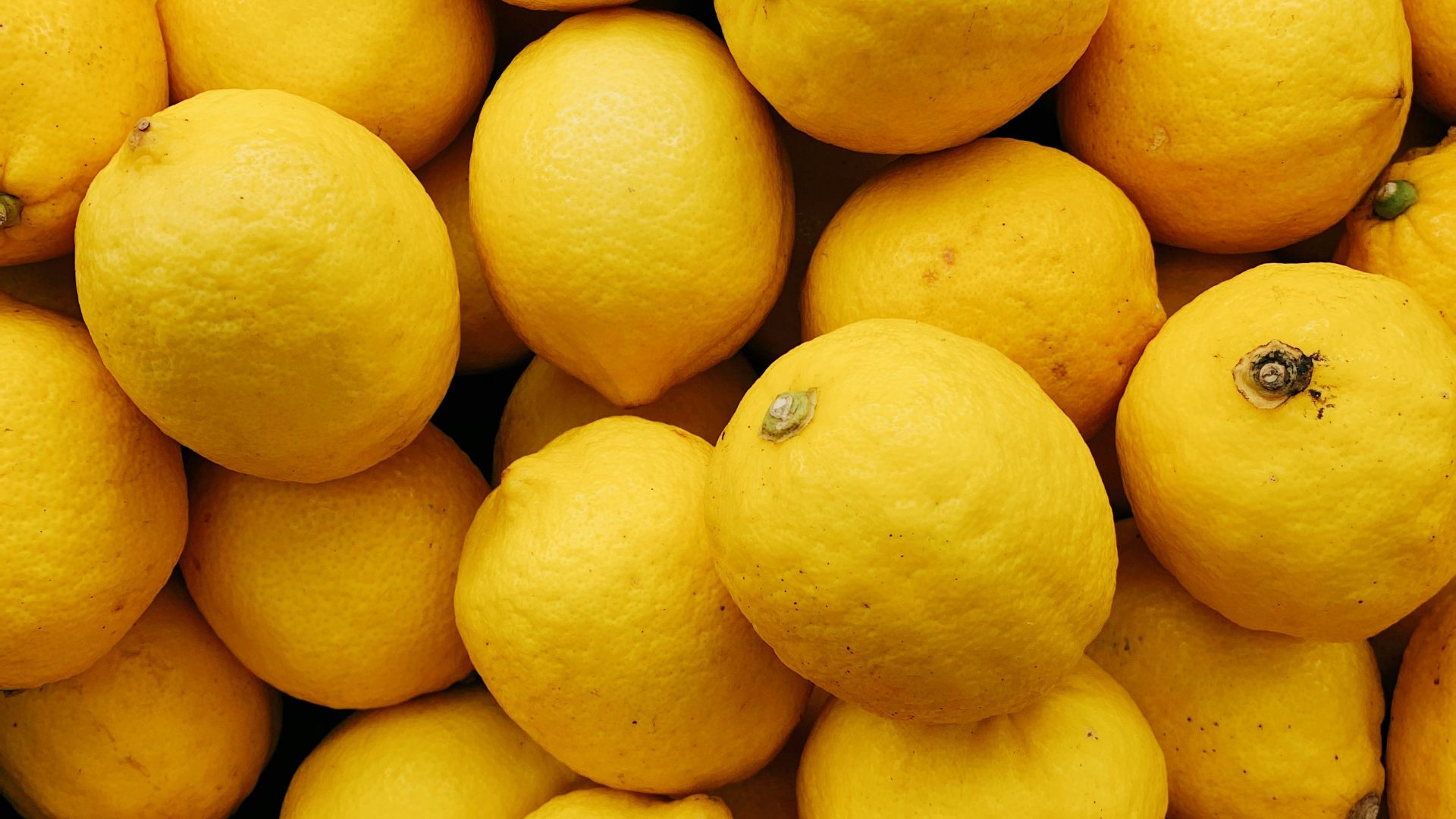 yellow citrus fruits on black surface