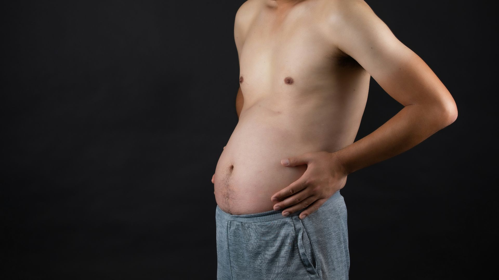 topless man in blue denim jeans